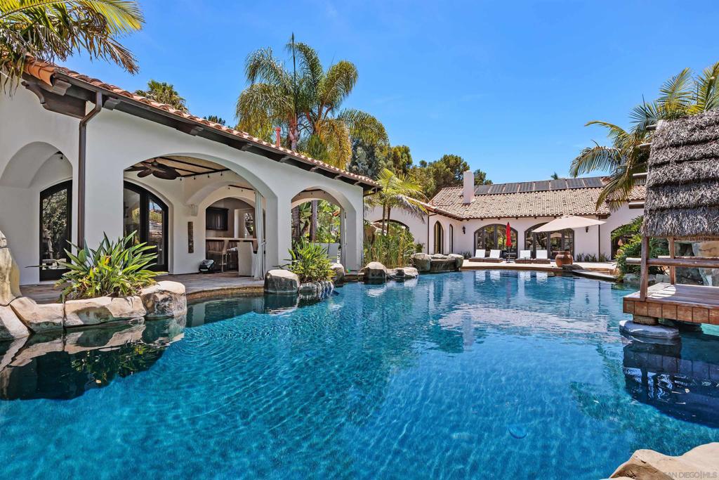 Barefoot luxury! Award-winning pool & BBQ area. This home is fun & has so much to offer. Light & bright with very high ceilings. Lives like a single-level w/Master, 3 BRs & executive office on the main level plus 1 BR & add. office upstairs. Huge rooms. Pool details include: Swim up bar, huge palapa, Balinese Lumbung, 4 waterfalls, water slide, Jacuzzi, outdoor kitchen, EVO BBQ grill. Separate pool room w/fully equipped gym. Sport court, infrared sauna, vegetable planting area, fruit trees. On nearly 2 acres. See 2nd VT for HGTV Award Winning pool - its the third listing on the show. https://www.hgtv.com/design/packages/hgtv-ultimate-outdoor-awards/2016/outdoor-oasis