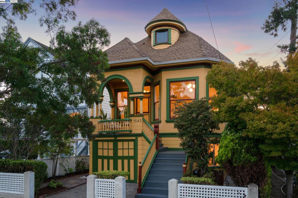 The best of island living awaits on coveted Bay Street in Central Alameda in this upgraded Victorian home with architectural splendor that lives like a 5-bedroom with 2 full baths and additional bonus rooms. Built in 1905, this enchanting 2513 SQFT home delights with its old world features including a neighborly porch, stained glass and bay windows, wainscoting, picture railings, pocket doors, carved woodwork, built-in cabinets, and hardwood floors. Sunshine streams into the large living and dining area that offers a nice place to relax with family and friends in front of the fireplace, and the adjacent eat-in kitchen is spacious with new countertops and fixtures. The upper floor is complete with two renovated bathrooms, three bright bedrooms, one with sliding glass doors onto a deck with pergola. Sip your morning coffee in the shade or step down to the wonderful backyard where you can entertain, unwind, and play surrounded by mature trees and landscaping. The home’s lower floor features two bedrooms, a laundry area, interior access to the garage, ample storage, den and bonus rooms offering flexible space ready for your imagination or as an office or playroom. Out your front door, enjoy Alameda’s great parks, beaches, schools, ferries, shopping & a Transbay bus stop a block away.