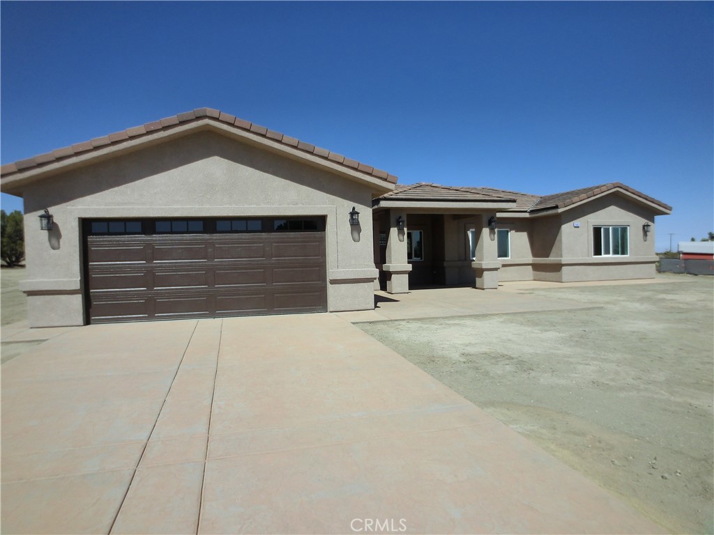 Welcome to your dream home! This custom built single family residence is the perfect home for any family. As you enter through the front door, you are greeted by an open floor plan with wood laminate waterproof flooring though out the house. The kitchen has quartz counters, all new appliances, and a walk-in pantry. There is a laundry room in the house with built in cabinets and a sink. All bedrooms have ceiling fans. The master suite has 2 walk-in closets and, dual sinks. The dining room has a slider that leads out to a covered patio with mountain views. The house also features a paid solar system and tankless water heater. There is room for RV storage on this 2 acre property.