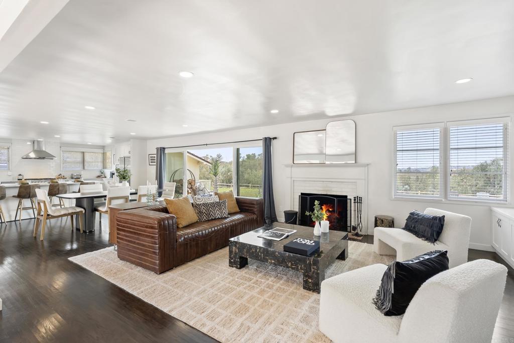 Perched atop 5.26 usable acres in the prestigious West Covenant of Rancho Santa Fe, this beautifully reimagined single-story Modern Ranch-style residence offers timeless design, privacy, and effortless California living. With 4 spacious bedrooms and an open-concept floor plan, the home is bathed in natural light and seamlessly blends indoor and outdoor living. Floor-to-ceiling glass sliders open to an expansive interior courtyard and western-facing meadow, capturing peaceful views and a touch of ocean on the horizon—perfect for golden-hour gatherings or quiet relaxation. The home is thoughtfully designed for entertaining, with a sparkling pool, bocce ball court, and a detached guest casita offering comfort and privacy for visitors. The gourmet kitchen features high-end appliances and sleek finishes, ideal for everyday living or hosting with ease. Located in the award-winning Roger Rowe School District and just minutes from both the historic Village of Rancho Santa Fe and the coast, this westside location is unmatched in convenience and serenity. With direct access to the community’s renowned trail system, 5306 Linea del Cielo is a rare opportunity to own a private, turn-key estate in one of Southern California’s most coveted enclaves.