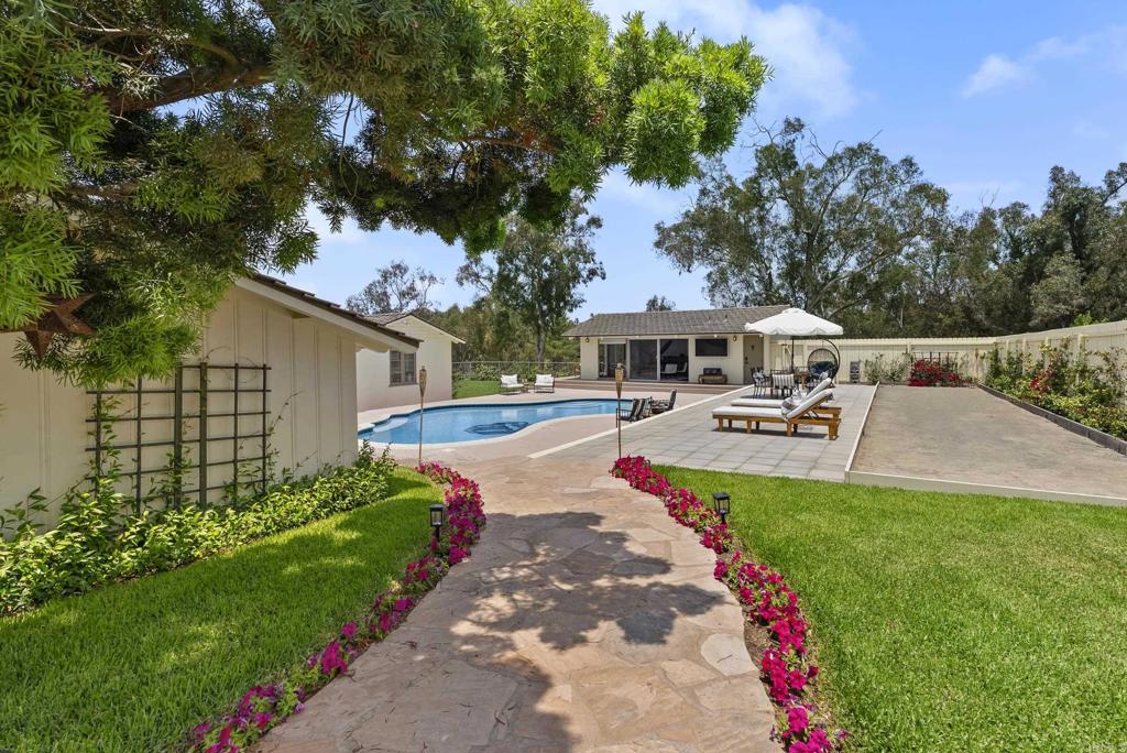 Perched atop 5.26 usable acres in the prestigious West Covenant of Rancho Santa Fe, this beautifully reimagined single-story Modern Ranch-style residence offers timeless design, privacy, and effortless California living. With 4 spacious bedrooms and an open-concept floor plan, the home is bathed in natural light and seamlessly blends indoor and outdoor living. Floor-to-ceiling glass sliders open to an expansive interior courtyard and western-facing meadow, capturing peaceful views and a touch of ocean on the horizon—perfect for golden-hour gatherings or quiet relaxation. The home is thoughtfully designed for entertaining, with a sparkling pool, bocce ball court, and a detached guest casita offering comfort and privacy for visitors. The gourmet kitchen features high-end appliances and sleek finishes, ideal for everyday living or hosting with ease. Located in the award-winning Roger Rowe School District and just minutes from both the historic Village of Rancho Santa Fe and the coast, this westside location is unmatched in convenience and serenity. With direct access to the community’s renowned trail system, 5306 Linea del Cielo is a rare opportunity to own a private, turn-key estate in one of Southern California’s most coveted enclaves.
