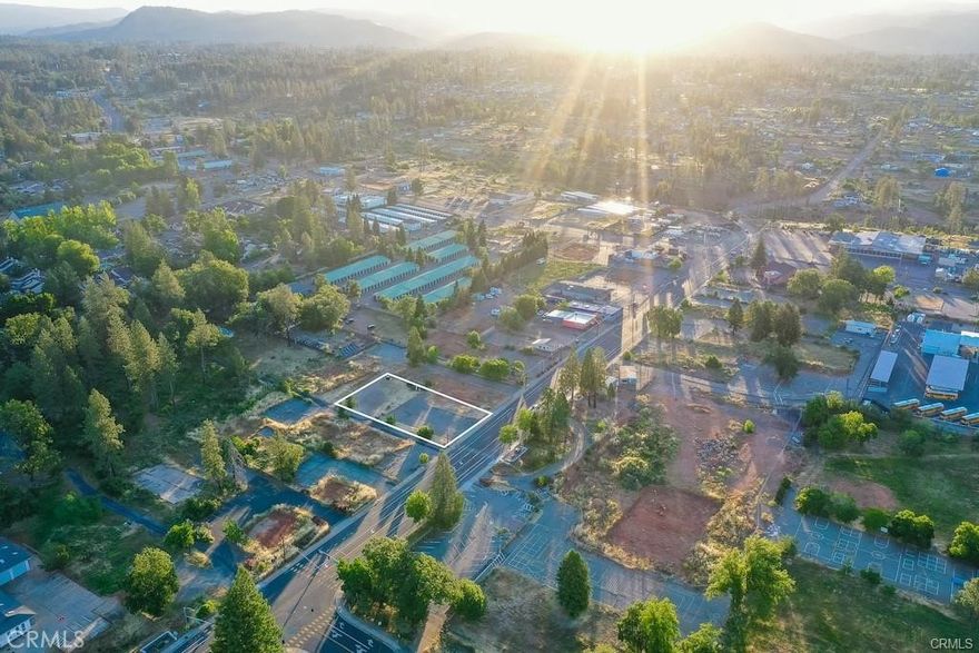 Welcome to a standout commercial opportunity in the heart of Paradise—directly across from PUSD’s brand-new elementary school currently under construction. This high-visibility parcel sits on a main thoroughfare with strong traffic counts and excellent frontage, offering an ideal setting for a future business in an up-and-coming community. Surrounded by schools, parks, the public pool, shopping, and revitalized town amenities, this location is perfectly positioned for growth. The site was once home to the well-known Dolly “O” Donuts, a longtime local landmark—now ready for its next chapter. Zoned CC – Community Commercial, the property supports a wide range of commercial uses. It lies within PID’s water service area (currently disconnected) and includes valuable existing infrastructure: a 1,500-gallon concrete septic tank and 1,500-gallon concrete grease tank, both installed in 2015. Investors should also review the Town of Paradise’s future sewer plans, which may further enhance development options. With more than a half-acre of usable land in a central, high-growth corridor, this is a rare opportunity to establish a flagship presence in the continuing rebuild of Paradise.