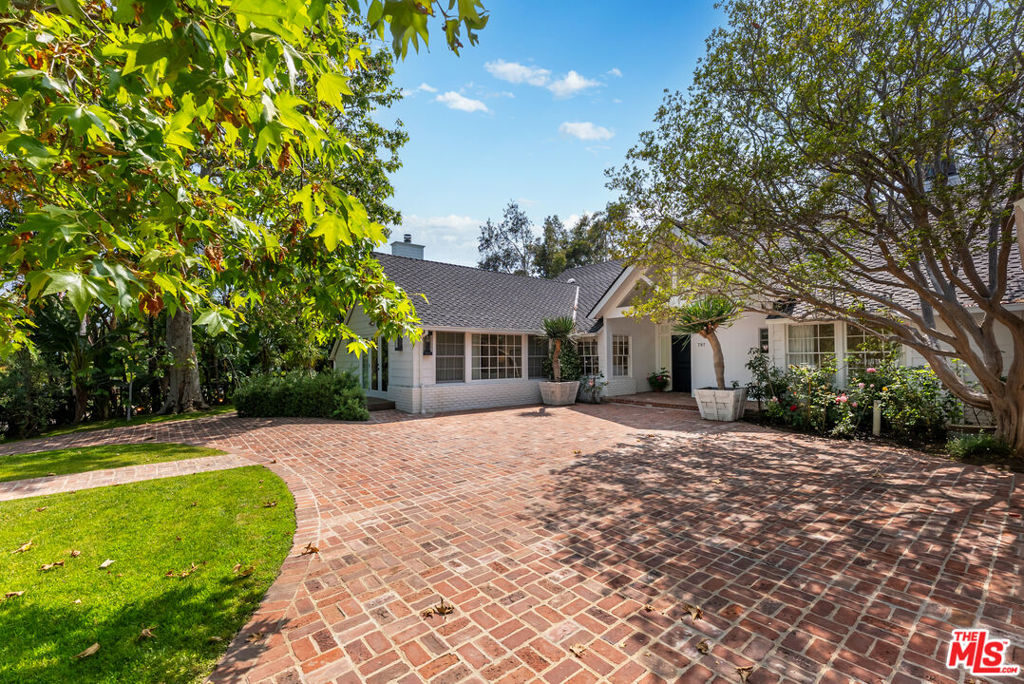 Private and gated single story Traditional beautifully remodeled. Expansive floor to ceiling stacking doors open to a magnificent backyard with stunning views facing west . Located on the " rim" the yard is large flat with gorgeous pool, outdoor chefs kitchen, dining area and firepit and multiple lounges. The main house has an easy open floorplan with all the rooms you will use to live and entertain. Wonderful Living room, formal dining room, built in office and great kitchen- breakfast that is open to the family room. The primary is large with floor to ceiling windows overlooking the back yard, a great bath and 2 walk in closets. There are 2 more ensuite bedrooms and baths on this side of the house. There's a large 4th bedroom ensuite off the family room and a guest bedroom/ bath in the converted garage. Plenty of parking in the circular driveway as well. This home is comfortably furnished and is available long or short term lease.