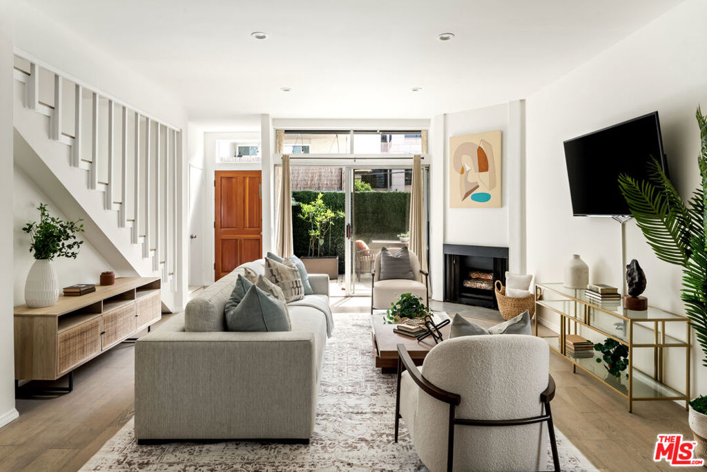 Experience the ease of living steps from Santa Monica's famous beaches and 3rd Street Promenade in a beautifully updated townhome just south of Wilshire. Offering 1,260 SF of living space with 2 bedrooms and 2 bathrooms, the home opens to a bright, spacious living room with wide-plank wood floors throughout. Step into the updated kitchen, featuring quartz counters, stainless steel appliances, and a tile backsplash. Upstairs, the primary suite creates a warm and relaxing retreat with its own balcony, while elegant bathroom remodels, both upstairs and down, showcase new vanities, fixtures, and tile. Additional features include 2 side-by-side parking spaces, a private patio connected to the living room, and in-unit laundry. All of this in the sought-after Roosevelt School District, just steps from the shops and cafes of Montana Avenue.