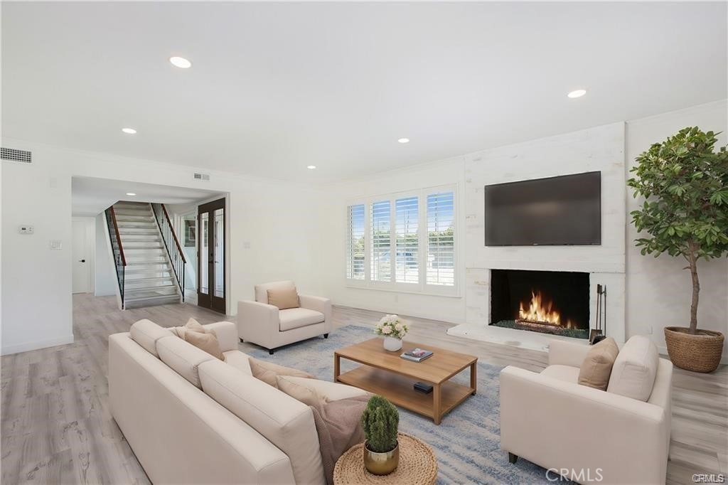 TURNKEY ! COMPLETELY REMODELED NORTH TUSTIN HOME ! DOWNSTAIRS PRIMARY BEDROOM ! SINGLE LOADED STREET ! NO NEIGHBOR IN FRONT ! Welcome Home ! 13772 Sanderstead is located in the highly sought-after North Tustin community & sits on a single-loaded street. This beautifully remodeled 4-bedroom, 2-bathroom residence exudes style & charm. Featuring a modern, open-concept floor plan, the home is enhanced with designer touches throughout, new flooring, fresh paint, and custom details — offering both elegance & charm in every detail. As you enter, you’re greeted by a formal entryway that seamlessly guides you into the spacious living area, where a cozy fireplace serves as the focal point. The kitchen has been beautifully remodeled & features elegant stone countertops, brand-new Samsung stainless-steel appliances, large kitchen island w/ wine refrigerator, & custom cabinetry. It opens to the dining & great rooms, creating the perfect space for hosting & entertaining.The dining room showcases a designer light fixture & offers the ultimate indoor-outdoor experience. French doors open to the entertainer’s backyard, seamlessly blending the two spaces for an ideal setting to enjoy both inside & outside living, The backyard has been meticulously designed w/ low-maintenance landscaping & feat. an outdoor fire pit providing the perfect spot for relaxation, offering complete privacy.The downstairs primary bedroom is generously sized, feat. new, extra large mirrored closet, recessed lighting, & direct access to the backyard. Its spacious design offers both comfort & convenience, creating a peaceful retreat w/ easy outdoor access.The downstairs primary bath is exquisite, feat. a luxurious steam room & shower combo. It boasts a new vanity with dual sinks & custom tile flooring & backsplash, creating a spa-like atmosphere with elegant, modern finishes.The second through forth bedrooms are impressively spacious, ea. feat. large mirrored closets, beamed ceilings, & an abundance of natural light. The secondary bath is stunning, showcasing a new Whirlpool bathtub & shower, along with a custom tile backsplash & vanity. The 2-car garage is notably spacious, providing ample room for extra storage. Additionally, the bonus room / den adds valuable square footage.This home is conveniently located to high-end shopping, popular restaurants, close to Beach Cities, and located w/ an award-winning school district !