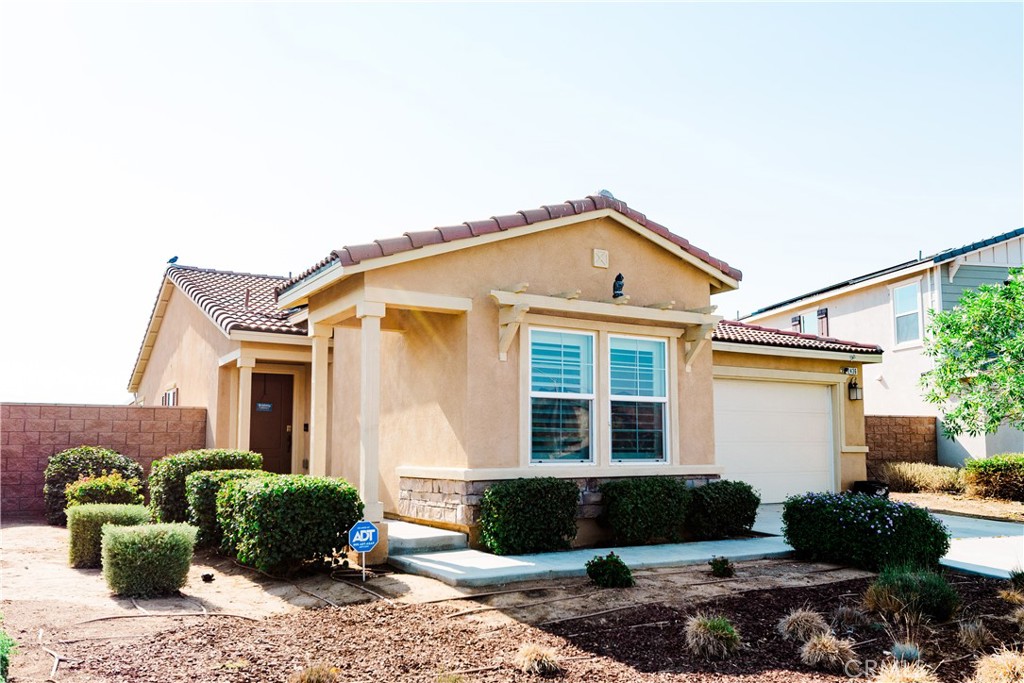 Beautiful Home! Welcome to this beautifully upgraded, nearly new home in a desirable Perris community! This residence has been lived in for only a few years and offers a modern open floor plan with modern finishes throughout. Step inside to discover luxury vinyl plank flooring flowing seamlessly through the spacious living areas. The contemporary kitchen overlooks the inviting living room, creating the perfect space for entertaining. Enjoy upgraded white cabinetry, sleek granite countertops, and stainless-steel appliances that add both style and functionality. The home is filled with natural light, and wood shutter window coverings. Outside, you’ll find a concrete covered patio, and actual grass. For added comfort and privacy, the secondary bedrooms are thoughtfully separated from the primary suite, creating a peaceful retreat for the homeowners. Additionally, you'll find a separate indoor laundry room for added convenience. This home is truly a must see! Don’t miss this opportunity to schedule a showing today!