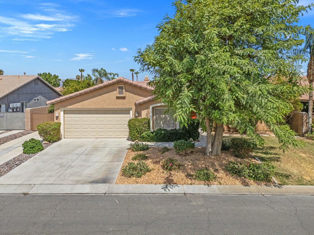 Enjoy the peace, quiet and security of gated Las Brisas N in this freshly painted 4 bedroom, 3 bath home with over 2000 sq ft. Expansive living area features high ceilings, formal dining room, living room, & family room with fireplace. Tile flooring separates family room from kitchen area with space in front of the island to add a casual dining table. Access to the backyard thru French doors allows a wonderful indoor/outdoor entertainment experience. Primary bedroom is spacious with access to the backyard thru it's own set of French doors. Ensuite bath has dual vanities, walk-in shower, & large walk-in closet. Down the hall there are two more bedrooms and a shared bath. The 4th bedroom and 3rd bath are located at the opposite end of the house near the kitchen and laundry room, perfect for guests or use as an office. The attached 2-car garage is conveniently accessed through the kitchen. Property is beautifully landscaped front & back. Lovely mature shade tree, grass, & verdant foliage in the front yard. Backyard has a concrete patio that extends the length of the house, pergola providing shade, and a huge expanse of grass perfect to add a private swimming pool. Located close to Costco, shopping, medical, & downtown events. Low HOA fees!
