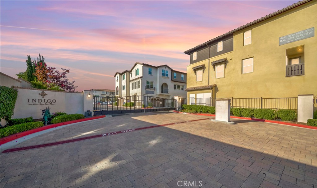 This stunning corner unit, built in 2021, features 3 spacious bedrooms + 1 bonus room/office (total 4 rooms) and 2.5 bathrooms, 1,700 sq ft of modern living space with a flexible open-concept floor plan, thoughtfully designed across three levels for privacy and functionality. The entry-level offers a versatile bonus room—perfect as a bedroom, office, or den, and the main living area is bright and inviting, featuring a large kitchen island with quartz countertops, stainless steel appliances, a generous pantry, and soft-close cabinets and drawers. Just off the kitchen and living room, a private balcony offers the perfect spot to relax or entertain. The top-floor primary suite includes a luxurious primary bathroom with dual sinks and a walk-in closet. Each bedroom is well-sized, with ample space for your furnishings. This energy-efficient home also boasts dual-pane windows, engineered laminate wood flooring, recessed lighting, and a high-efficiency HVAC system and tankless water heater. Residents of The Indigo Walk enjoy resort-style amenities including a BBQ area, community park, dog park, and nearby retail shops and with easy freeway access—this home truly combines comfort, convenience, and value. This house is a must-see, so don't miss this great opportunity. It will not last long on the market!