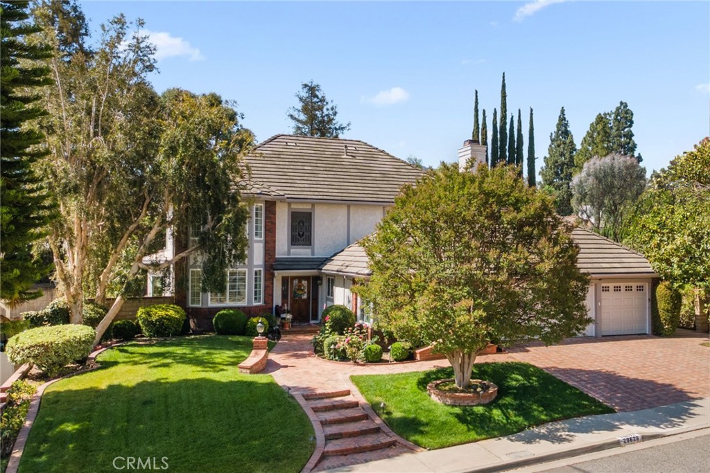 Tucked between two cul-de-sacs in one of Agoura’s most desirable neighborhoods, Morrison South, this beautifully maintained 4 bedroom plus office home offers the perfect blend of comfortable and privileged living. Big 3 car garage, luscious vegetation and landscaping, and mature trees start building the story of this home before you’re even inside. Upon entry, you are in a sun filled two story foyer with a curved staircase and gorgeous hardwood floors- leading to all major living areas. Spacious dining room between the formal entry and kitchen area collects enough sun to keep your food warm. One private bedroom corridor downstairs which also hosts a bathroom. The living and family room are side by side and in between them is a custom wood wet bar. Lot’s of incredible wood craftsmanship in this home- crown molding all around, custom cabinetry in the family room, wet bar, and the window and door treatment brings a synchronized design to the house. The kitchen includes cherry wood cabinetry, granite countertops, stainless appliances, and a peninsula ideal for prepping, baking, or serving guests. Before you go to the yard from the family room, the kitchen includes a breakfast nook with another point of access to the backyard and directly into a pergola. Outside is a true entertainer’s yard: Oversized pool/spa, BBQ with side burner, pergola covered dining area, and a grassy area perfect for barefoot lounging. Upstairs, the primary suite spans the entire rear of the home and features a private office with wet bar, a large bath with soaking tub, walk in shower, dual vanities, and a fully organized walk in closet. Two more generously sized bedrooms share an updated dual-sink bathroom. Solar on the roof! Unbeatable location near shopping, dining, open space, and top-rated Las Virgenes schools.
