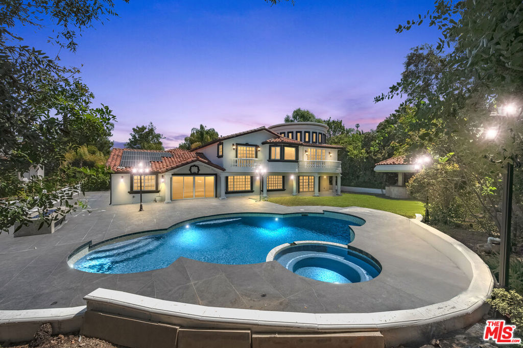 This grand residence features soaring high ceilings, expansive living spaces, and a thoughtfully updated interior perfect for both entertaining and family life. A stunning onyx stone bar with LED lighting serves as a showpiece for gatherings, while large windows throughout capture sweeping, serene vistas. Located in a peaceful and safe neighborhood, this home offers the perfect balance of privacy and community. The tasteful updates throughout provide a modern touch while preserving its warm, inviting feel. A rare opportunity to lease a property that truly feels like home. Enjoy energy efficiency with solar panels and exclusive access to a private community tennis court. Can also be leased fully furnished for an additional rate, making it move-in ready for a truly elevated living experience.