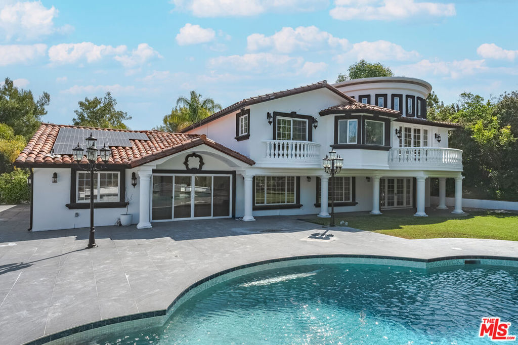 This grand residence features soaring high ceilings, expansive living spaces, and a thoughtfully updated interior perfect for both entertaining and family life. A stunning onyx stone bar with LED lighting serves as a showpiece for gatherings, while large windows throughout capture sweeping, serene vistas. Located in a peaceful and safe neighborhood, this home offers the perfect balance of privacy and community. The tasteful updates throughout provide a modern touch while preserving its warm, inviting feel. A rare opportunity to lease a property that truly feels like home. Enjoy energy efficiency with solar panels and exclusive access to a private community tennis court. Can also be leased fully furnished for an additional rate, making it move-in ready for a truly elevated living experience.