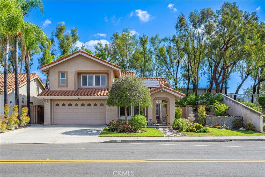 Discover a private, spacious home filled with natural light. This extremely attractive four-bedroom, three-bathroom home is located in the heart of Rancho Santa Margarita, close to top-rated schools, shopping, dining, parks, and impressive community amenities. From the attractive entry courtyard to the open-plan interior and large back yard, this is a home for comfortable indoor-outdoor living and entertaining. The lower level, with stained glass in the front door and adjacent window, has soaring ceilings, flooring, and seamless flow between the living, family, dining, and kitchen. The kitchen, which has generous work space and a large garden window, has beautifully upgraded cabinets, countertops, and stainless appliances, plus an adjoining comfortable family room with a fireplace. This opens to a huge bonus room with a full closet and sliding glass doors to the backyard. Upstairs, four bedrooms with all new carpeting include a primary suite with an updated bathroom and large closet. There are two full baths upstairs and one full bath downstairs. With a greenbelt and no neighbors on one side, the house has lovely landscaping in the front, where a gated entry leads to a charming patio. The serene backyard, with fruit trees, has a large patio perfect for outdoor dining, barbecues, and relaxing. The home’s additional features include central air, ceiling fans, and owned solar panels. Community amenities include, Rancho Santa Margarita Beach Club; beautiful lake, lagoon; swimming pools; parks with playgrounds, picnic areas, and sports facilities; and an extensive urban trail system for hiking and biking. A magnificent home of exceptional quality and appeal.