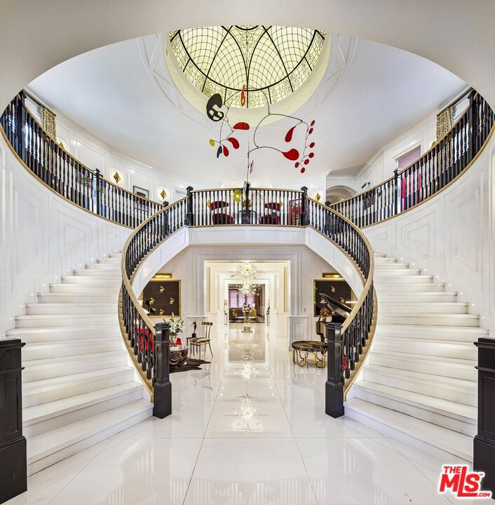 Experience the epitome of luxury in this one-of-a-kind glamorous estate, boasting a resort-style backyard and a guest house, all within a gated and private setting. As you enter through the majestic 2-story grand entrance of appx 14,740 SF , you'll be enveloped in an ambiance of opulence, highlighted by a double staircase beneath a breathtaking rotunda. The expansive living areas showcase high ceilings, exquisite wood and marble floors, and meticulous attention to detail, seamlessly blending contemporary design with timeless craftsmanship to create an atmosphere of refined indulgence.The main level offers a spacious family room flowing into a double island gourmet kitchen equipped with state-of-the-art appliances, a food pantry, butler's pantry, formal living room, formal dining room, spa room with jacuzzi and sauna, gym, power office, glam room, two powder rooms, and a home theater.Upstairs, discover an opulent primary suite featuring three custom-designed walk-in closets and dual primary baths, along with four additional guest bedrooms, each with its own en-suite bathroom and custom designer walk-in closet.Step outside to the backyard, a true private resort-like paradise, featuring a large shimmering pool and spa, sunken fire pit, putting green, basketball, outdoor BBQ, cabana with chef's kitchen boasting top-of-the-line appliances and a pizza oven. Completing this outdoor oasis is a pool cabana/spa and a two-story, two-bedroom guest house complete with a salon.Embrace the luxury of living in your own private oasis, a truly unique and unparalleled estate.