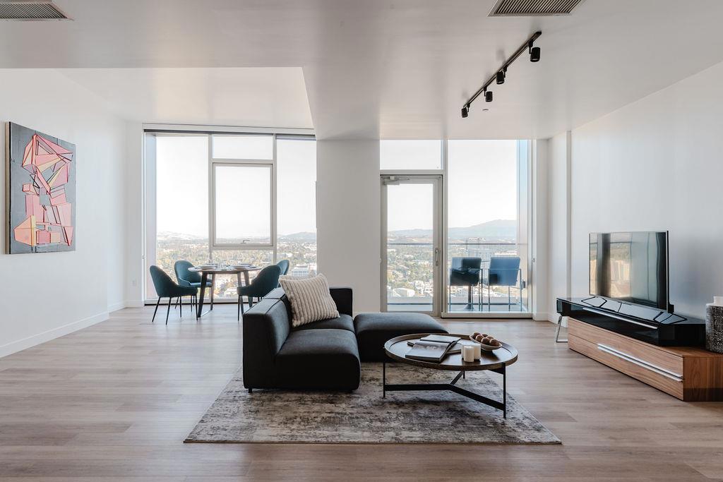 Discover the pinnacle of urban sophistication in this 27th-floor penthouse, offering sweeping city views. Floor-to-ceiling windows flood the space with natural light, while a private balcony affords elevated outdoor moments. The open-concept design seamlessly blends high-end finishes with functionality, featuring a modern kitchen complete with an island, bar seating, abundant storage, wine fridge and premium Miele appliances. The primary suite is a serene retreat, offering ample closet space and a spa-inspired bathroom with heated floors and a calming rain shower. Thoughtful conveniences like a full-size washer and dryer add to the ease of daily living. Community amenities redefine luxury, boasting 24/7 concierge, a resort-style rooftop pool with cabanas and grills, a state-of-the-art fitness center, a bark park, and round-the-clock security. Designer spaces like a private art gallery and breathtaking rooftop views enhance the ambiance. Relax at the Sky Deck fire pits or gather in the private dining suite. Penthouse residents receive complimentary membership to The House - a private social club that affords exclusive experiences such as Chefs Table Dinners & Twilight Tastings. This residence is more than a home; it's a lifestyle, crafted for those who expect the extraordinary.