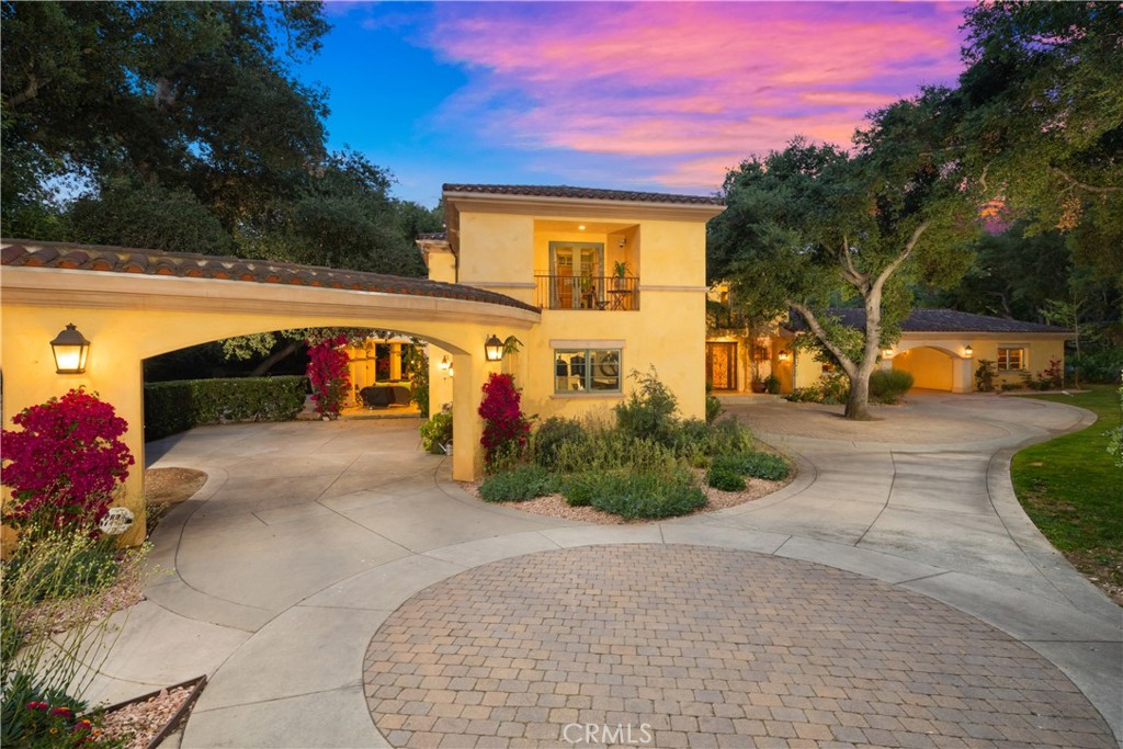Welcome to this hidden gem in the heart of La Cañada Flintridge offering luxurious living with thoughtful sustainability. Built by the current owners in 2005 and lovingly maintained ever since, this is the first time the home has ever been on the market, presenting a rare opportunity to own a custom estate that has never changed hands. Set behind a fully gated perimeter and surrounded by lush, mature landscaping, the property sits on a serene, park-like lot with only one neighboring home. Offering unmatched privacy, tranquility, and a lifestyle tailored for both comfort and entertainment. Designed with long-term sustainability in mind, the estate features 38 Panasonic solar panels and four Tesla Powerwalls, all fully paid off and installed prior to recent changes in energy credit rates by SCE. This investment results in incredibly low utility bills, often averaging just $60 per month, even with dual EVs charging & full-time A/C use. Two spacious garages include EV charging, overhead storage, and one is outfitted with a professional-grade car lift, perfect for car enthusiasts. Outdoor amenities elevate this property into a private resort. The newly resurfaced pebble-bottom pool is the centerpiece, surrounded by multiple seating areas designed for both relaxation and entertaining. A lit basketball/pickleball court, expansive upper deck, covered ATV/trailer parking, and vibrant rock gardens with bougainvillea and succulents complete the picturesque grounds. A storage shed sits beneath the deck, and private trail access provides a direct connection to nearby nature paths, ideal for morning hikes or sunset strolls. Inside, the home features an exquisite blend of natural materials and fine finishes, including walnut & Brazilian cherry woodwork, travertine & marble flooring, and a striking custom floating iron staircase. The sound-insulated McIntosh home theater, with 7 powered recliners, is hidden behind handcrafted wood doors, offering a true cinematic escape. Additional highlights include a fully equipped gym/ADU, 3 laundry areas, and a spa-like primary suite with steam shower, garden views, and ample closet space. Recent upgrades such as a tankless water heater, automated gate motors, and refreshed landscaping reflect the pride of ownership & attention to detail throughout. Blending timeless design, energy efficiency, and resort-style amenities, this exceptional estate offers a rare opportunity to live in one of La Cañada’s most coveted and private enclaves.