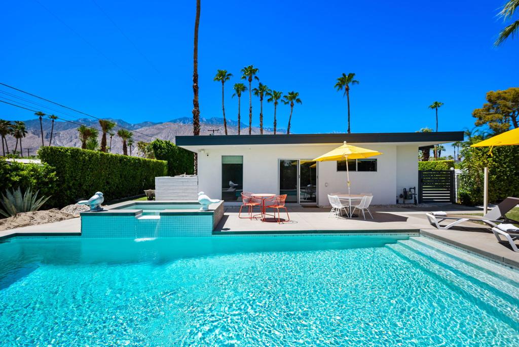 Renovated Mid-Century in Sunrise Park - Central Palm Springs. Experience the perfect blend of iconic mid-century architecture and today's modern luxuries in this fully renovated Sunrise Park stunner. Behind lush privacy hedges and a gated drive, this home offers style, comfort, and sophistication just minutes from downtown Palm Springs. Crisp, clean lines and open, flowing living spaces highlight the glamour of the era, while sliding doors blur the lines between indoors and out. A brick fireplace anchors the living area, perfectly creating an ambiance. The updated kitchen is a contemporary showpiece, featuring stainless steel appliances, striking countertops, designer backsplash, and a peninsula breakfast bar that opens to the family room--ideal for entertaining. Newer tile flooring throughout, remodeled baths, updated fixtures, and modern lighting enhance the home's fresh, cohesive design. Attractive floorplan with primary suite away from other bedrooms. Dining room for formal meals and gatherings. Step outside to your own private oasis. Beautifully landscaped grounds balance low-maintenance desert plantings with lush greenery. The large patio provides multiple seating and dining areas, all oriented toward dramatic mountain vistas. A sparkling pool and spa invite sunny afternoons, starlit evenings, and effortless gatherings with friends and family. This home is more than a residence--it's a lifestyle. Lounge by the pool, entertain in style, or take a quick jaunt into town for dining, shopping, and events. With its unbeatable location, move-in-ready renovations, and undeniable Palm Springs charm, this is the quintessential desert retreat you've been waiting for.