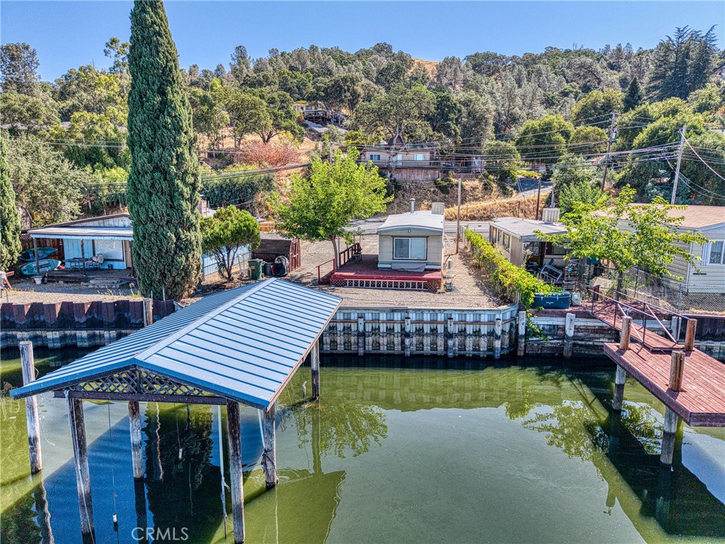 Lakefront 2 bed, 1 bath home with tons of potential! This single-wide sits on a fully fenced 0.16-acre lot and features new interior flooring, paint, windows, a covered deck, and newly installed dual heating/cooling. Enjoy stunning views of Clearlake from the deck or the large living room windows. Boat lift with metal roof (motor needs some TLC), storage shed, and space to grow or redevelop. Only a few miles to a great public boat dock—perfect for weekend getaways, fishing tournaments or future investment!