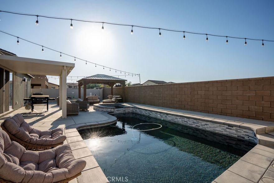 Welcome to your SINGLE STORY dream POOL home in the highly desired neighborhood of Spencer's crossing on the east side of Murrieta! This stunning single-story residence offers 4 spacious bedrooms, 3 full bathrooms, and 2,806 sq. ft. of beautifully designed living space. Step inside and be greeted by a wide open floor plan featuring modern LVP flooring and a seamless flow perfect for both everyday living and entertaining. The heart of the home is the gorgeous kitchen, showcasing a large granite island, sleek cabinetry, stainless steel appliances, and a walk-in pantry for maximum storage. Natural light pours into every corner, highlighting the home’s clean lines and stylish finishes. Step outside to your private backyard oasis complete with a firepit, custom pebble tech pool and spa with low-maintenance landscaping—ideal for relaxing or hosting friends. And with FULLY PAID OFF SOLAR, enjoy major savings and energy efficiency year-round. Located in a beautiful community featuring multiple pools, parks, and a vibrant community center, this home offers both luxury and lifestyle.

Don’t miss your chance to own this move-in ready East Murrieta gem!