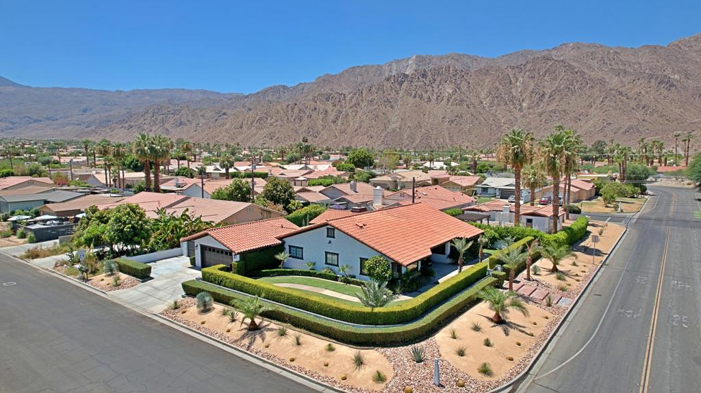 Welcome to 77655 Avenida Montezuma, a beautifully upgraded desert retreat located in the La Quinta Cove. This spacious single-family home sits on a rare elevated double corner lot totaling approximately 10,018 square feet, offering majestic mountain views, enhanced privacy, and expanded outdoor living space. The well-maintained landscaped grounds include an extra parking space for an RV or boat, adding versatility and convenience.With 3 bedrooms, 3 bathrooms, and 2,202 square feet of living space, the home features soaring beamed ceilings, a grand fireplace, and an open-concept layout ideal for entertaining. The kitchen is appointed with granite countertops, tile backsplash, upgraded stainless steel appliances, and custom cabinetry. Tile flooring flows throughout the main living areas, while carpeting adds comfort to the bedrooms.The primary suite opens directly to a private backyard oasis complete with a sparkling pool, gas fire pit, mature landscaping, and block wall fencing. Additional highlights include a bonus room, indoor laundry with attic storage, attached garage, and a new complete energy-efficient AC system. The property benefits from low-cost utilities through Imperial Irrigation District and is located in a non-HOA neighborhood within the Desert Sands Unified School District.Enjoy close proximity to Old Town La Quinta's boutique shopping, fine dining, and weekend farmers markets. Outdoor enthusiasts will appreciate nearby access to the Santa Rosa Mountain hiking and biking trails, while sports and entertainment lovers are minutes from the Indian Wells Tennis Garden and Empire Polo Grounds, home to Coachella and Stagecoach. Golfers will find themselves surrounded by world-class courses including SilverRock Resort, La Quinta Resort & Club, and PGA West.Whether you're seeking a full-time residence, vacation getaway, or investment opportunity, this home offers the perfect blend of lifestyle, location, and value. Schedule your private showing today and experience the best of desert living.