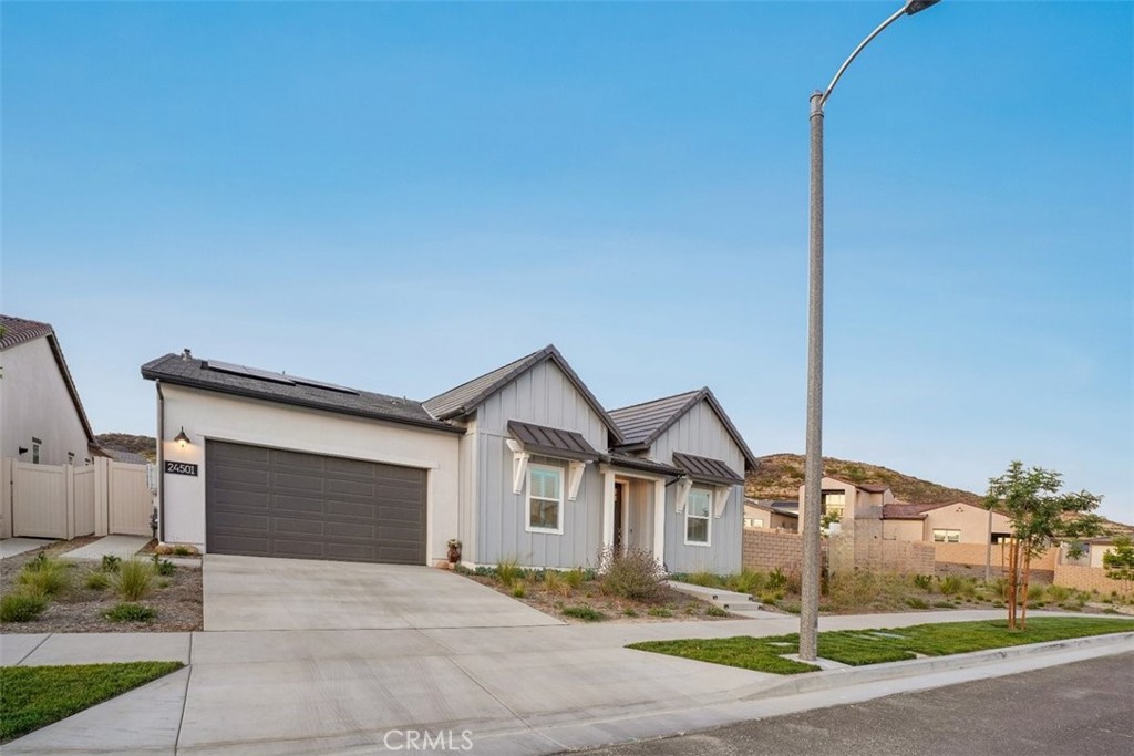 One-of-a-Kind Resort-Style Home on Rare Dual-Parcel Lot in Gated 55+ Community! Welcome to 24501 Via Sendero, a stunning 2024-built residence located on a massive corner lot with two separate APNs (3244-161-036 & 3244-161-037) in the highly desirable Estrada 3 at Tesoro Highlands Valencia community. This is one of the few homes offering such an expansive lot, delivering privacy, space, and exceptional value. Experience elegant resort-style living in this immaculate 3-bedroom + office, 3.5-bathroom home with approximately 2,550 sq ft of open-concept luxury. Step inside to find premium vinyl wood flooring, soaring high ceilings, and a thoughtfully designed layout ideal for comfort and entertaining. The custom 4-panel sliding glass doors seamlessly connect indoor and outdoor living spaces.
The chef’s kitchen is a showstopper—equipped with a 6-burner gas range and built-in griddle, stainless steel appliances, a spacious island with seating, modern countertops, designer backsplash, a dry bar, and abundant cabinetry. A walk-in pantry with custom wood shelving and a large laundry room with ample storage add everyday convenience.
Retreat to the luxurious primary suite with direct patio access, a generous walk-in closet, and spacious bathroom ensuite featuring dual sinks and a large walk-in shower with bench seating. All the 3 bedrooms feature ceiling fans with light fixtures for year-round comfort.
Enjoy California living at its best in the resort-style backyard with low maintenance paved backyard- ideal for entertaining family and friends.
Additional highlights include:
Owned solar panels with a capacity of 10 Watts
Tesla Battery
Central A/C & heating
Tankless water heater
EV charger
2-car attached garage with direct access
Designer lighting & chandeliers throughout
Enjoy premier 55+ gated living with clubhouse access, recreational facilities, fitness center, swimming pools & spa, pickleball courts, dog park, and a full calendar of lifestyle events and social activities are located right behind the house at a walking distance. Don’t miss this rare opportunity to own a modern, move-in ready home with unmatched space and amenities in one of Valencia’s finest active adult communities. Truly a place to call home.