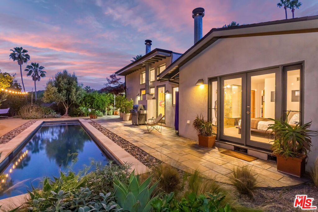 Exceptional, architect-owned, custom-designed Mid-Century gem on a 10,000+ SF Lot in highly coveted Laurel Canyon, known for its creative community and top-rated Wonderland School. The beautifully landscaped front garden, with native plants and raised boxes with fresh herbs & vegetables offers a striking yet serene welcome. This meticulously cared for home features designer finishes, custom wood windows/doors, high ceilings, skylights, and a seamless floor plan flooded with natural light. At the heart of the home is a gourmet kitchen with bulthaup cabinetry, center island, Sub-Zero fridge, Bosch double oven, Miele dishwasher, Gaggenau gas cooktop, and walk-in pantry, perfectly positioned to face a spacious family room, creating a central hub where family and friends come together. Whether it's Sunday breakfast, holiday gatherings, or game night, it's the kind of space where memories are made. The living room offers a cozy fireplace and garden views. Featuring three bedrooms with custom built-ins & roomy closets, two designer baths and a thoughtfully designed hallway workspace with built-in desk and storage. Gorgeous private backyard with a newer lap pool/spa, fruit trees, and plenty of space to BBQ, dine al fresco, or simply unwind after a busy week. Other highlights include a newer roof, new 5-Ton heat-pump rooftop packaged HVAC, 2 car garage with 2 EV chargers, fully paid off solar panels, 3 fireplaces, and security package with CCTV monitoring system. This prime Hollywood Hills location is located steps from Mulholland Drive with easy access to Sunset Boulevard, Beverly Hills, Studio City, hiking trails, Mulholland Tennis club and Wonderland School.