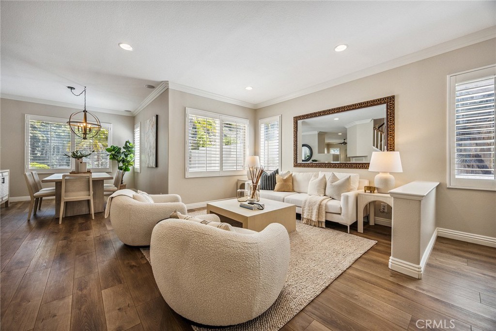 Spacious home in the perfect location! Modern amenities meet designer perfection. Adorned with custom plantation shutters, stylish light fixtures, soothing designer paint tones, and rich crown molding throughout this home embodies sophisticated warmth. The expansive kitchen is a chef’s dream, showcasing updated shaker-style custom cabinetry, elegant quartz countertops, a large center island, and a cozy casual dining nook. Enjoy effortless entertaining in the formal living and dining rooms, or gather in the inviting family room with a fireplace and direct access to the backyard oasis. Handsome wood look flooring flows throughout the lower level creating a warm welcoming atmosphere, while plush brand-new carpeting adds comfort upstairs. A conveniently located downstairs bedroom with a full bath offers flexibility for guests or multigenerational living. Ascend the stairs and retreat to the luxurious primary suite, complete with an updated en-suite bath featuring a separate jetted tub and shower, quartz countertops with dual vanities, richly toned cabinetry, and custom mirrors. Two additional upstairs bedrooms share an updated Jack and Jill full bath while the 5th bedroom could serve as an oversized office. The versatile open loft provides an ideal space for a game room or lounge, complete with a custom climbing wall. Outdoors, the fully usable backyard with new vinyl privacy fence creates a personal paradise — enjoy a covered patio for al fresco dining, and a rock-accented, heated pool and spa perfect for relaxing or entertaining year round. Desirable 3 car garage, large laundry room and within walking distance to Running Springs Elementary. In addition you are moments away to restaurants, shopping, hiking trails, parks, and an easy commuter location as well. The perfect package awaits!