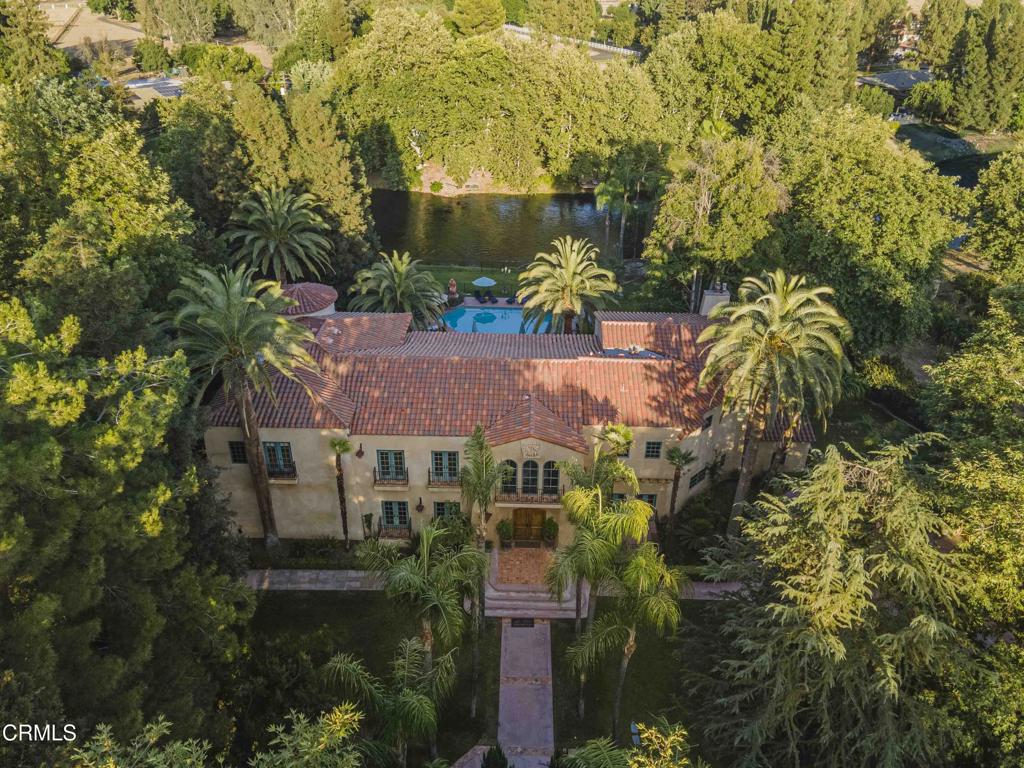 One-of-a-kind Tuscan Villa situated on a 2.5 acre lot on the Kern River and surrounded by hundreds of mature trees. The architectural detail in this home is amazing. There is a central atrium w/ a dramatic staircase and numerous French doors on both levels. Much of the home has unique flooring consisting of pavers surrounded by inlaid wood. The game room is huge and features a full bar, a floor-to-ceiling, flagstone fireplace, an exposed beam ceiling and an entertainment center. There is an elegant formal dining room w/ wood paneling and a gorgeous chandelier and a formal living room which has a lovely fireplace and numerous French doors and large windows. The backyard is breathtaking w/ a large, covered patio topped by an extensive balcony overlooking the river and the surrounding hills, a pool, a built-in BBQ, an outdoor fireplace, a firepit and more. The gourmet kitchen has beautiful custom cabinets and high-end appliances and there is a detached 4-car garage with 2 bonus rooms.