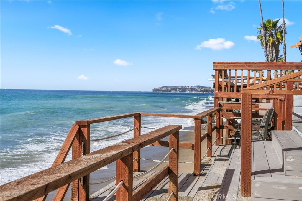 Set along the sand in the exclusive, guard-gated enclave of Beach Road in Dana Point, this oceanfront property offers a rare opportunity for investment or personal enjoyment. Currently arranged as a duplex, the single-level structure hosts two updated three-bedroom, two-bath units—each with direct beach access and sweeping views of Catalina Island, the Pacific Ocean, stunning sunsets, and Dana Point’s iconic Headlands. Together totaling approximately 2,106 square feet, both units showcase open-concept living with tile flooring, soaring ceilings, indoor laundry, and spacious living areas that open to patios overlooking the ocean.The kitchens have been modernized with granite countertops and stainless-steel appliances, while upgraded windows and sliding doors invite in natural light and sea breezes. A recently updated deck adds durability and long-term value. Sitting on a homesite more than 100 feet deep and over 6,000 square feet in size, the lot extends all the way to the median high-tide line—an extraordinary advantage for California coastal real estate. Whether you choose to rent both units, live in one and lease the other, or build a custom oceanfront retreat, the possibilities are abundant. Beach Road spans nearly 1.5 miles of private beach and features approximately 185 residences. Its unmatched location offers easy access to Dana Point’s Lantern District, harbor, beaches, coastal trails, shops, restaurants, and nearby destinations including Laguna Beach and San Clemente.