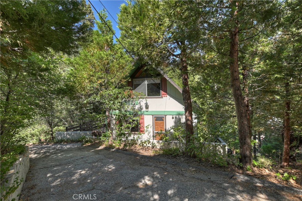 Discover the charm of Lake Arrowhead living with this vintage 3-bedroom, 2-bath home situated on a generous, tree-studded lot just moments from the lake. Brimming with character, this classic mountain retreat offers cozy living spaces, original architectural details, and the potential to personalize or preserve its timeless style. Whether you're seeking a weekend getaway or a full-time residence, you'll appreciate the peaceful setting, ample outdoor space, and proximity to lake access, lake trails, and village amenities. A rare opportunity to own a piece of Lake Arrowhead history in an ideal location.