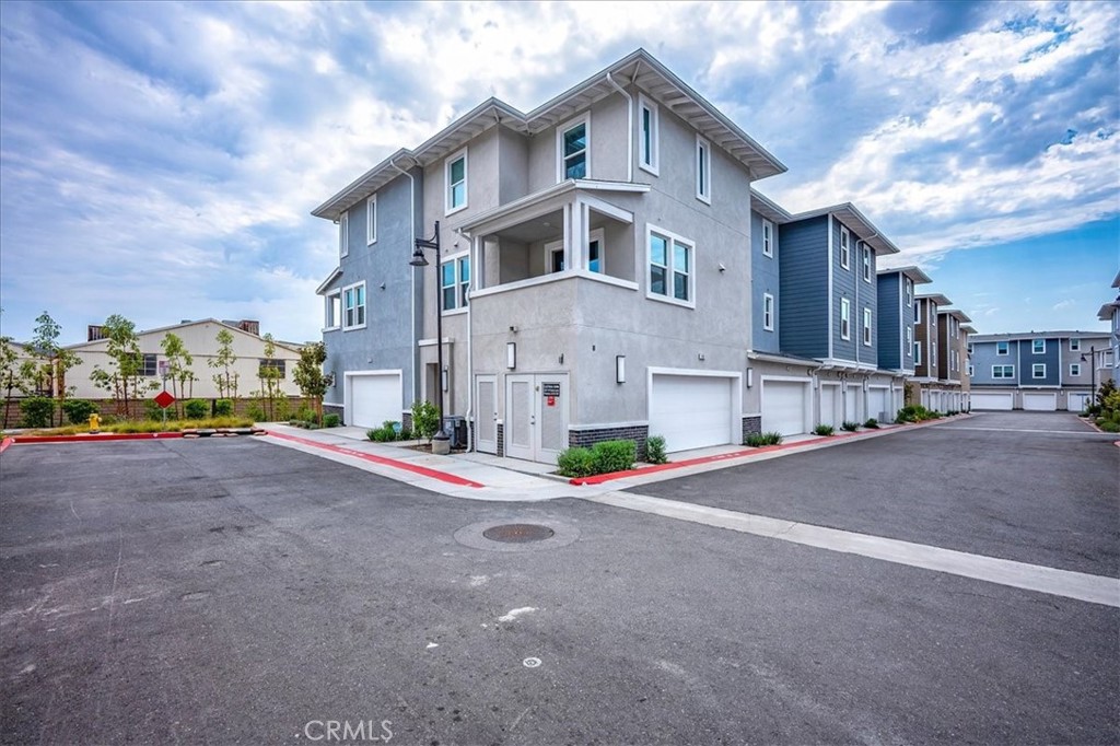Fabulous energy efficient end unit, 2br town home with owned solar! This immaculate property is located across from Casa Colina, approx one mile from historic downtown La Verne, University of La Verne, Pomona Valley Hospital, and only two miles from the Claremont Village and Colleges! Walk or ride your bike to amazing shops and dining!! Three levels of luxurious living, including LV floors and plush carpeting throughout, a neutral design pallet, high ceilings and panoramic dual pane windows. The main level showcases a gourmet kitchen with crisp white cabinetry, quartz counter tops providing an abundance of prep surface, large island with pull up bar seating, stainless steel appliances and storage pantry, plus dining area leading to spacious balcony with mountain views, creating indoor/outdoor living. Immediately adjacent is the open concept family room with free standing electric fireplace and wall of light filled windows. The convenient half bath completes this level. There are two spacious bedrooms and full baths on the third level, including the relaxing primary with walk in closet, and en-suite boasting a dual sink vanity, quartz counter tops and glass enclosed oversized shower . The stackable washer and dryer are located on this level, providing convenience and ease of use. Spacious two car attached garage, charming dog park and common area maintenance, as well as the incredible location, make this the perfect place to call home!