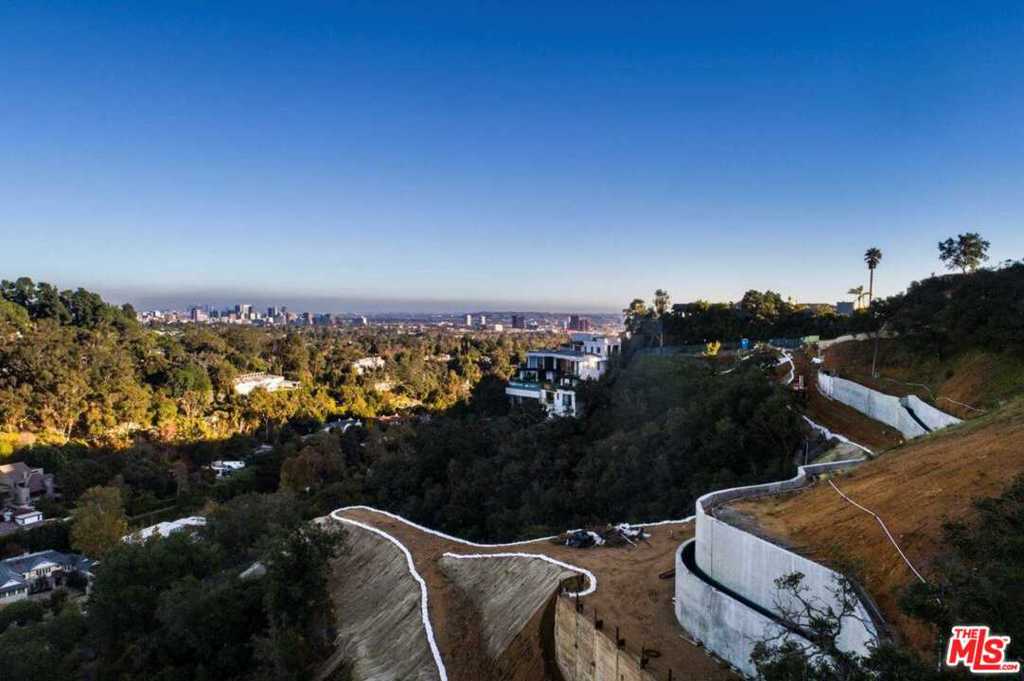 This is an exceptional opportunity to acquire prime real estate in Brentwood. Nestled on 3.39 acres of meticulously cultivated land, this property epitomizes luxury living at its finest. Boasting over $5,000,000 already invested in grading and caisson work, this parcel is primed for the realization of a bespoke estate. Upon arrival, guests are greeted by completed front gates, enhancing privacy and security, while a grand 290-foot private driveway sets the stage for an impressive entrance. Included with this unparalleled offering are ready-to-issue (RTI) plans for a magnificent 8-bedroom residence. The architectural plans showcase a lavish abode featuring a sprawling 4000 square foot garage, ideal for the avid car collector or enthusiast. Within the estate, indulgent amenities await, including a, a sumptuous theater, and an inviting infinity pool offering panoramic views of the picturesque landscape. Complementing the main residence is a separate 2-bedroom guest house, providing luxurious accommodations for visitors or staff. Whether as a private sanctuary for the discerning homeowner or an esteemed investment opportunity, this parcel promises a lifestyle of unparalleled luxury and distinction.