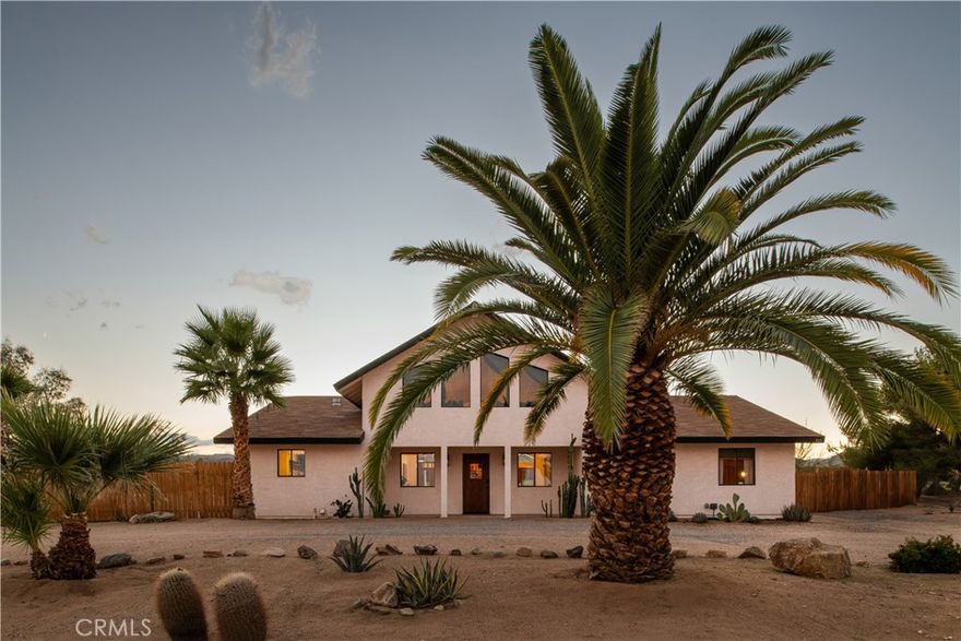 There are houses in the desert, and then there are homes that feel like works of art. West & Wild is the latter - a retreat that embodies design, intention, and soul. Featured in Architectural Digest, Vogue, and Sight Unseen, this iconic property has captured global attention while remaining a deeply personal, creative escape. With a proven history as one of the desert’s most beloved short-term rentals, West & Wild also offers an established legacy of strong revenue and glowing reviews - a home where investment and artistry coexist in perfect balance. Its design blends scale with intimacy - from a soaring, light-drenched living room crowned by a cathedral ceiling of warm wood, to walls finished in lime-wash and Roman clay that bring subtle depth and texture. The chef’s kitchen with dramatic stone counters and high-end appliances, along with carefully curated furnishings and artwork, speaks to a vision where every detail matters. The 2,400+ sqft main house holds three bedrooms plus a versatile loft - perfect for extra guests, a lounge, or a creative studio. Just steps away, a private casita with its own bath completes the four-bedroom retreat, offering privacy and connection in equal measure.

Outdoors, the energy shifts into pure desert magic: a hand-painted swimming pool by artist Ty Williams, a hot tub beneath endless stars, a communal fire pit for gatherings, and trails leading into the wide-open landscape near the scenic Sand-to-Snow National Monument. The backyard is expansive, offering a large stretch of flat, buildable space beyond the pool - the perfect canvas for future expansion, whether that’s an additional structure, outdoor wellness space, sport court, or any creative desert amenity. The home also features a fully owned solar system, aligning with the same intentional, forward-thinking design that defines every detail throughout. This home is more than beautiful design - it’s an experience - a place where silence feels restorative, where morning light inspires, and where evenings bring together friends, creativity, and conversation. Perfectly situated in Flamingo Heights, you’re walking distance to the locally beloved La Copine, and minutes from Joshua Tree National Park and all the cafes, restaurants, and shops in downtown Yucca Valley, Joshua Tree, and Pioneertown. More than a home, it’s an expression of artistry and intention - ready for the next visionary to carry its story forward.