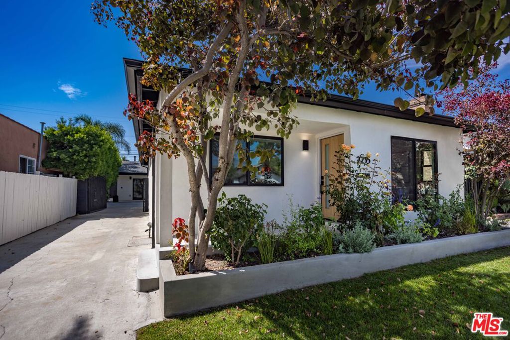 Welcome to this meticulously renovated, fully permitted Mid-City estate with a stunning ground-up ADU, seamlessly blending high-end living with flexible income potential. The beautifully crafted main residence features 3 bedrooms and 2 baths, showcasing Shell Beach engineered hardwood floors, custom white oak cabinetry, KitchenAid appliances, Bedrosian Quartzite Taj Mahal countertops, and bespoke mahogany exterior doors. Designer tiles and Kohler/Delta fixtures in the baths evoke spa-like comfort. The detached ADU (2 beds, 1 bath, 815 sq ft) mirrors the craftsmanship of the main house and offers its own private gated entrance, complemented by secure, electric-gated parking. The property itself is fully gated for added privacy ideal for multigenerational living, guests, or rental income. Two fully paid-off solar systems (valued up to $300/month) boost both efficiency and appeal. Located just off the 10 Freeway with effortless access to the 405, 110, and 101, this property places you within 58 miles of LAX, Inglewood, Santa Monica, Downtown LA, and Beverly Hills connecting you easily to top destinations. It's also near major healthcare institutions like Cedars-Sinai and Ronald Reagan UCLA Medical Center, and universities including USC, UCLA, and LMU. This listing delivers sophisticated design, smart efficiency, and strategic location an outstanding opportunity for owner-occupiers, investors, or those pursuing flexible, upscale living in Los Angeles. Schedule your visit today and discover this fully gated showpiece for yourself.