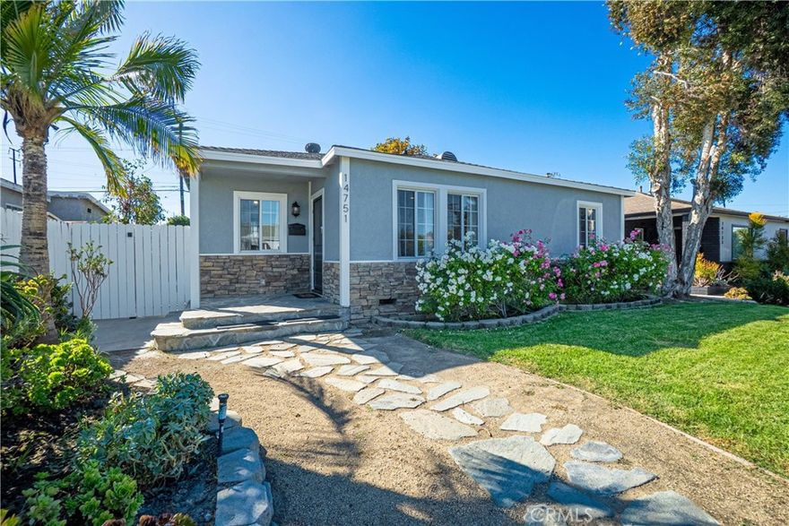 Welcome to 14751 Wadkins Ave, a charming and move-in ready home, waiting for you! This delightful property features beautiful original hardwood floors throughout the main living areas, complemented by tile floors in the kitchen and bathroom. The home boasts several appealing updates, including energy-efficient dual-pane windows, modern granite counters in the kitchen, and an elegant coffered ceiling in the living room. Perfectly situated, you'll be just 5 minutes from El Camino College and Alondra Park and a short drive to the beach, offering the best of South Bay living. The backyard provides ample space for relaxing and enjoying the Southern California sunshine, and a detached two-car garage with convenient alley access completes this must-see package. This one won't last long!