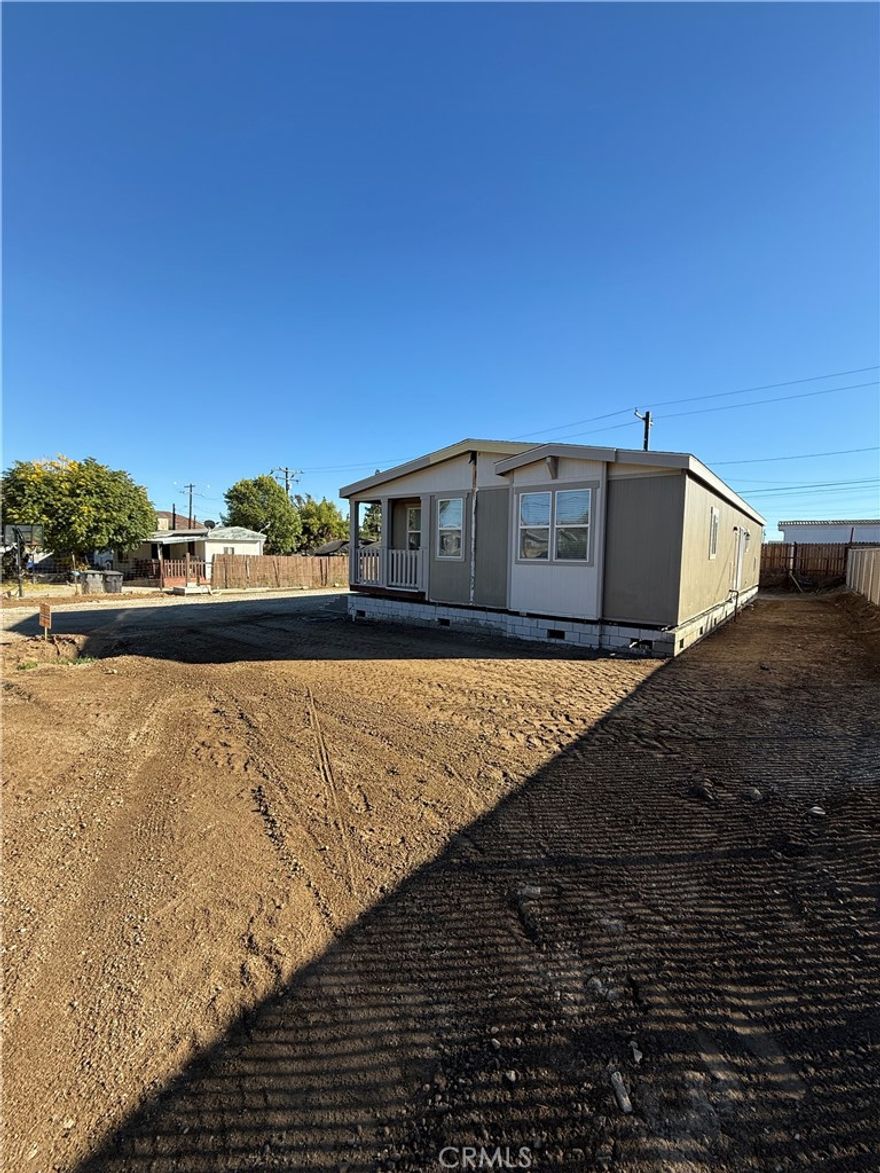 Welcome to this Brand New Manufactured Home on a permanent foundation, located in Hemet. This 3-bedroom, 2-bath home features a charming front porch and a bright, open floor plan. The kitchen is highlighted by quartz countertops throughout, ample cabinetry, and a spacious walk-in pantry, making it perfect for everyday living and entertaining. The primary suite offers a relaxing retreat with a large walk-in closet and private bath. Quality finishes and functional design make this home move-in ready and a must see.

Completed Photos coming soon!