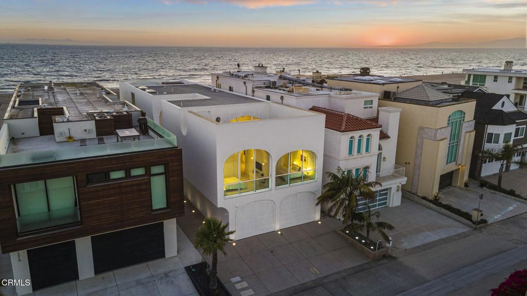 The Vault House - A Modern Architectural Icon on Mandalay Shores.Welcome to The Vault House, a globally recognized architectural masterpiece designed by Johnston Marklee, set on the sands of Mandalay Shores with 40 feet of coveted oceanfront. Located on one of the largest beachfront lots, the home extends beyond the neighboring residences to the north and south offering unmatched privacy and truly exceptional panoramic views.This one-of-a-kind residence offers 3,727 square feet of visionary design, seamlessly blending form, function, and natural light to create an unforgettable beachfront living experience.Featuring 4 spacious bedrooms and 5 luxurious bathrooms, the home is organized through a rhythmic series of unidirectional vaulted rooms, each sculpted to frame ocean views and filter sunlight throughout. Elevated above the sand for coastal resilience, the primary living spaces are arranged across a soaring, vaulted interior that feels both expansive and intimate.At the heart of the home is a sunlit courtyard that connects public and private wings, with vaulted ceilings varying in curvature to define each space from the sleek kitchen to serene sleeping quarters. The architecture is both minimalist and monumental, with a crisp white exterior made of seamless Grail Coat and warm limestone floors flowing throughout the interior.The contemporary layout encourages indoor-outdoor living, capturing panoramic views of the Pacific Ocean from multiple vantage points. Built to the highest coastal engineering standards, the foundation is designed to withstand the elements while the inland-facing garage is thoughtfully engineered to absorb impact in the event of storm surge.Winner of multiple international awards including Wallpaper Magazine's Best New Private House and an American Architecture Awards. The Vault House is more than a home. It's a museum-worthy statement on the future of coastal architecture.Rarely does a property of this architectural significance come to market. Come experience modern beachfront living like never before.
