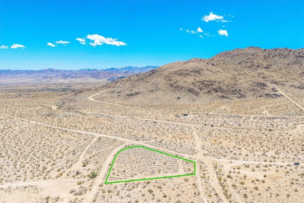 Discover the perfect canvas for your desert dream retreat on this 1.89-acre parcel in Joshua Tree. This expansive lot offers wide-open space and breathtaking panoramic views of the surrounding desert landscape and mountains. Just a short drive to Joshua Tree National Park and local amenities, this property is ideal for building a custom home, vacation rental, or peaceful getaway. Buyer to verify all utilities and zoning.