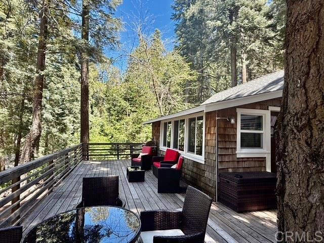 Have you been dreaming of slipping away to a beautiful, four season, forest setting? How about a truly authentic cabin tucked away with all the modern conveniences? Cedar Crest had been enjoyed as a full-time home and recently is a much-loved, Five Star Vacation Rental. When the snow is falling, cozy up in front of the efficient wood stove or use the remotes to turn on the mini splits that also provide heat and welcoming AC in the warmer weather. Everything you see in the photos could be an option for you. The owners have so many updates with the custom kitchen and poured-in-place counter tops on either side of the range. You'll love the under-counter two door refrigerator/freezer and microwave with beautiful wood counters. There is also a full-sized refrigerator in the basement storage area/workshop. How about a fenced yard? A generator set up is waiting for you, too and so much more! Just imagine relaxing on the deck with family and friends... come on up for a tour!