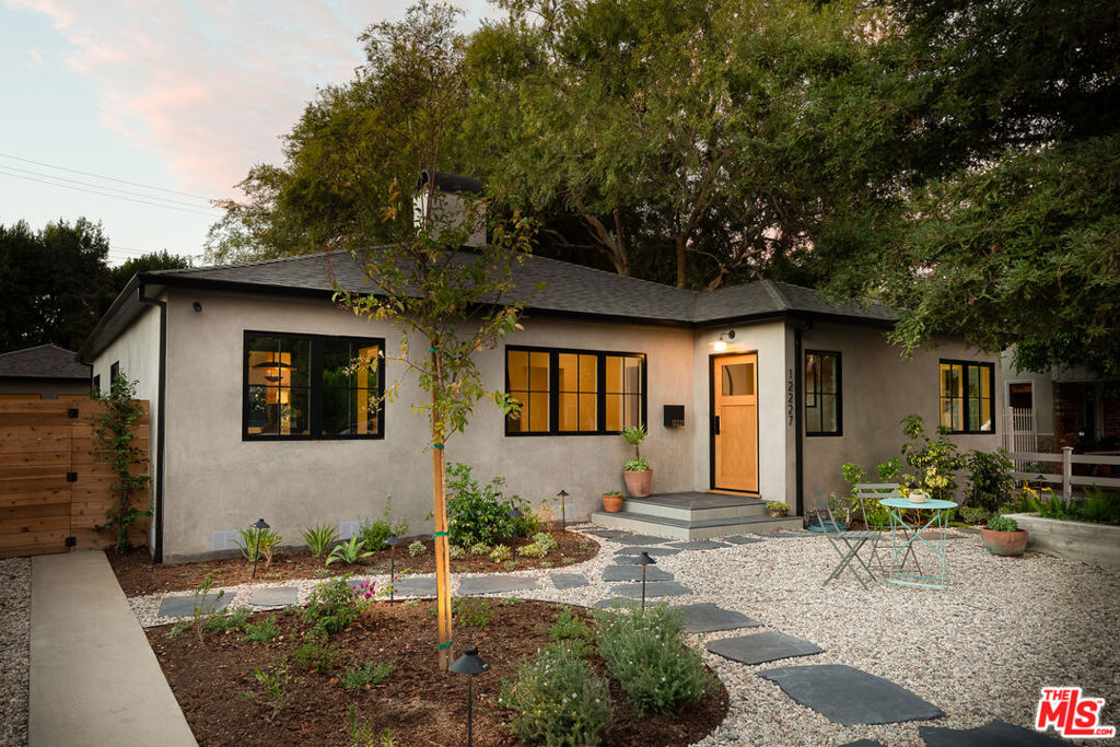 Introducing a beautifully reimagined residence that blends timeless charm with modern luxury. Situated in Valley Village, this home has been completely remodeled with high end finishes and thoughtful details throughout. The main house features 3 bedrooms and 2.5 elegantly updated bathrooms with an open floor plan that flows effortlessly, showcasing living and dining areas for both entertaining and refined everyday living. The converted garage offers endless possibilities whether as a guest suite, office or recreation room  with its own bathroom for elevated comfort and privacy. With large French and bi-folding doors opening out to the new spacious pool, this home is a perfect retreat to enjoy Southern California living. Positioned in prime Valley Village, this home combines convenience and charm just minutes from the highly regarded Colfax Elementary School, Ventura Blvd., and freeway access. Don't miss this opportunity to make it yours!