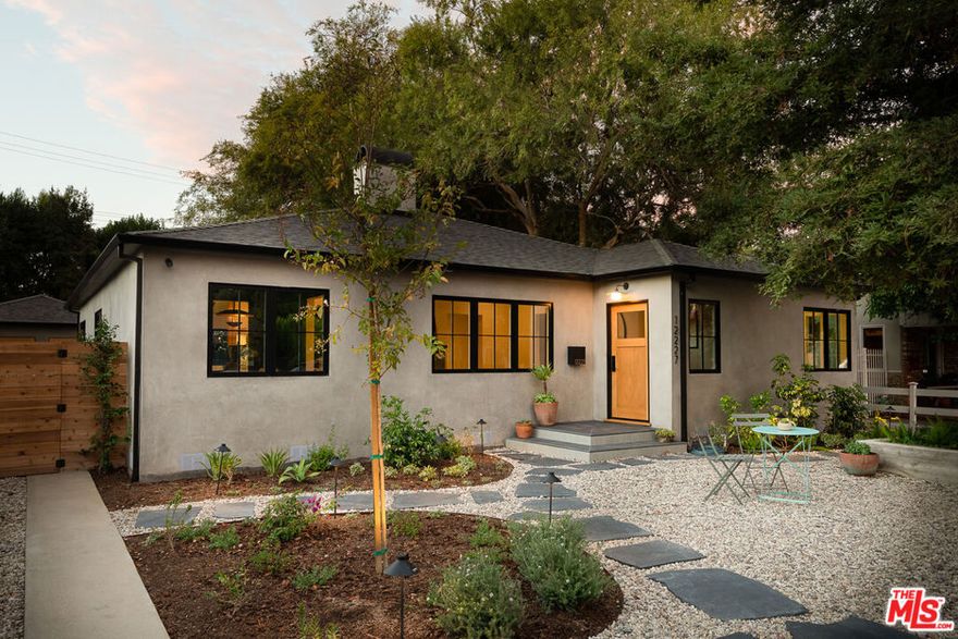 Introducing a beautifully reimagined residence that blends timeless charm with modern luxury. Situated in Valley Village, this home has been completely remodeled with high end finishes and thoughtful details throughout. The main house features 3 bedrooms and 2.5 elegantly updated bathrooms with an open floor plan that flows effortlessly, showcasing living and dining areas for both entertaining and refined everyday living. The converted garage offers endless possibilities whether as a guest suite, office or recreation room  with its own bathroom for elevated comfort and privacy. With large French and bi-folding doors opening out to the new spacious pool, this home is a perfect retreat to enjoy Southern California living. Positioned in prime Valley Village, this home combines convenience and charm just minutes from the highly regarded Colfax Elementary School, Ventura Blvd., and freeway access. Don't miss this opportunity to make it yours!