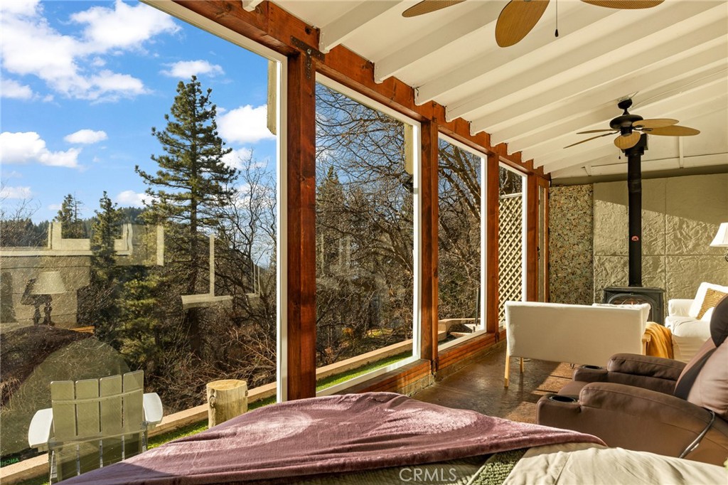 Nestled in the heart of Running Springs, this unique property is designed for those who crave tranquility and modern mountain living. Offering 3 bedrooms, 2 bathrooms, sunroom, three fireplaces, AC and amazing views! Step into the main level with primary bedroom, three-quarter bathroom, and open-concept living area with fireplace that flows seamlessly into the kitchen. The enclosed sunroom with wood burning stove is a standout feature on the main level, bathing the home in natural light and offering panoramic views of the surrounding forest, where towering pines and wildlife create a breathtaking backdrop. Upstairs you will find the additional two bedrooms, one of which has its own fireplace and custom built-in trundle bed. The second level also offers a full bathroom with laundry, and back deck with endless views. Outside, the large parking pad provides ample space for multiple vehicles making this home as practical as it is picturesque. Upgrades include new front retaining walls built in 2024, tankless electric hot water heater in 2022, and AC split units installed in 2020. Whether you’re a weekend adventurer or seeking a full-time mountain sanctuary, this property delivers unmatched charm and functionality. Conveniently located just one street over from local shops and dining, 15 minutes to Lake Arrowhead, and 25 minutes to Big Bear or Highland via Hwy 18 and Hwy 330. Schedule your private tour today and experience the magic of mountain living!