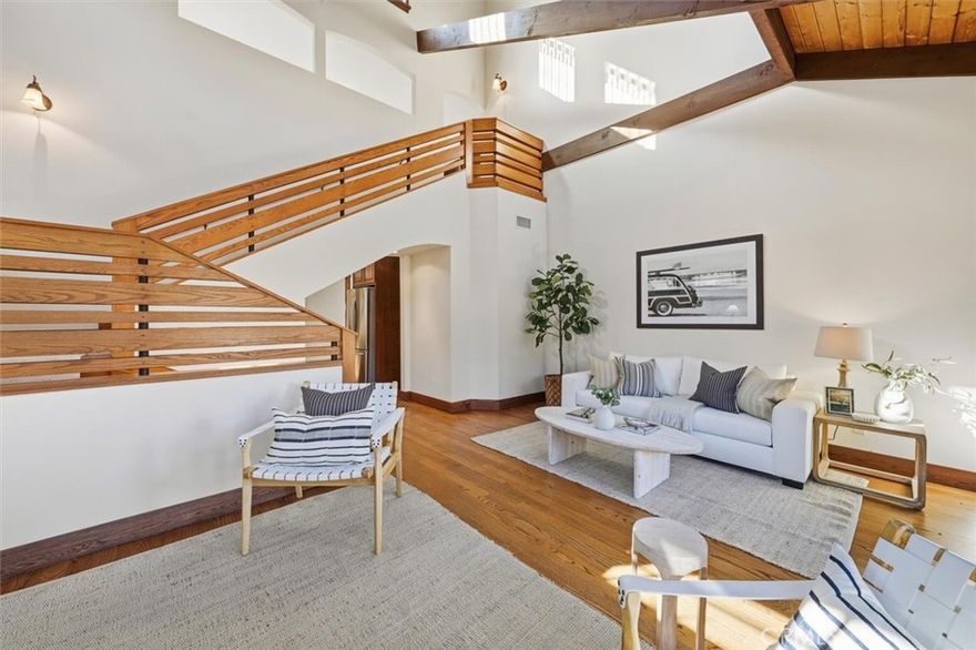 Enter this modern craftsman redesign with soaring ceilings for that spacious feeling.  The natural sunlight fills all the rooms of this architecturally distinctive home.  There are authentic Andersen Art Glass Panel windows and solid oak doors throughout.  The open family room and updated kitchen provide that relaxed living space for the family.  There are wood floors,  beam ceilings, and a fireplace in the family room.  The primary suite is large with a huge walk-in closet and is located on the first level.  The primary bath has a soaking tub and a tumbled tile shower.  Also, there is a door for easy access to the spa and back patio. The upstairs bedrooms and loft are large with cathedral beam ceilings and views of the neighborhood surrounding green treetops.  The loft is perfect for your home office, hobby room, or kids’ playroom.  The rear yard is sheltered for outdoor entertaining with a beautiful hardwood deck (Mangeris, Red Balau with clips - not nails). The pergola provides comfort shade while BBQing or enjoying the outdoors, and still more yard for playing.  This home backs up to the PV walking trail and is a short walk to Riviera Elementary. Perfectly located in the upper Riviera.