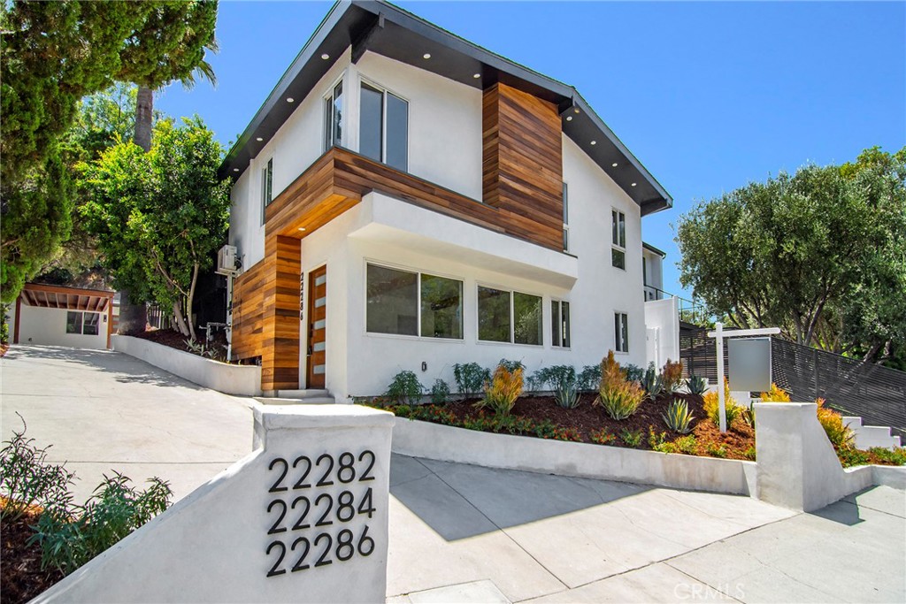 22284-Main House: 4 bd, 3.5 bth, 2012 Sqft. ADU: 22282: 1 bd, 1 bth, 538 Sq Ft. 22286-ADU: 1 bd, 1 bth, 800 sq ft.
Welcome to this stunning, fully remodeled legal triplex located south of the Boulevard in one of Woodland Hills’ most desirable pockets. Just steps from vibrant shops, restaurants, and cafes, this unique property combines the charm of mid-century design with modern functionality—ideal for investors, multi-generational living, or owner-occupants seeking supplemental income.The main house is the star of the show, boasting dramatic floor-to-ceiling windows that flood the living space with natural light and create a seamless connection to the outdoors. With a strong nod to mid-century modern design, the home overlooks a flat, grassy backyard—a perfect setting for summer entertaining or quiet relaxation.Two additional fully remodeled units provide flexibility and income potential. The lower-level unit, located beneath the main home, offers a private entrance, sleek finishes, and a thoughtful layout. The third unit, a standalone rear dwelling, also features its own entrance and has been designed with comfort and privacy in mind. All three units have been extensively renovated in a clean, contemporary style that feels fresh, timeless, and move-in ready. Each unit enjoys its own laundry hookups and private address, offering true independence for occupants. A spacious driveway provides ample parking for all three units—an increasingly rare convenience in this area.Whether you’re looking for a stylish investment, a multi-family compound, or a primary residence with built-in rental income, this exceptional triplex delivers on every level.