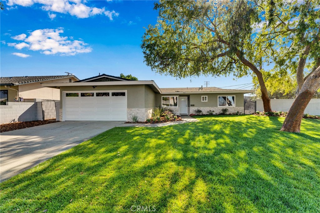 Welcome to this beautifully renovated single-story ranch-style home that combines modern updates with timeless charm. Step inside to find new windows, stylish light fixtures, and fresh finishes throughout. The heart of the home features a fully updated kitchen with stainless steel appliances and a cozy breakfast nook, while the dining area flows smoothly into the living room, complete with a tiled accent wall and fireplace. Both bathrooms have been thoughtfully remodeled, and one of the bedrooms is perfectly situated at the front of the house for privacy or a home office. Outside, enjoy the freshly landscaped front yard with new sod and vibrant flowers, plus a new concrete driveway leading to the attached 2-car garage. The expansive backyard is a blank canvas ideal for a future pool, garden, or outdoor entertaining space. A mature grapefruit tree, block wall fencing, and a covered patio spanning the back of the home provide shade, privacy, and plenty of potential. This move-in ready home truly has it all: modern upgrades, functional layout, and a yard that invites your imagination. ***Added Bonus*** New roof will be installed before the close of escrow!!
<<Click on the virtual tour>>