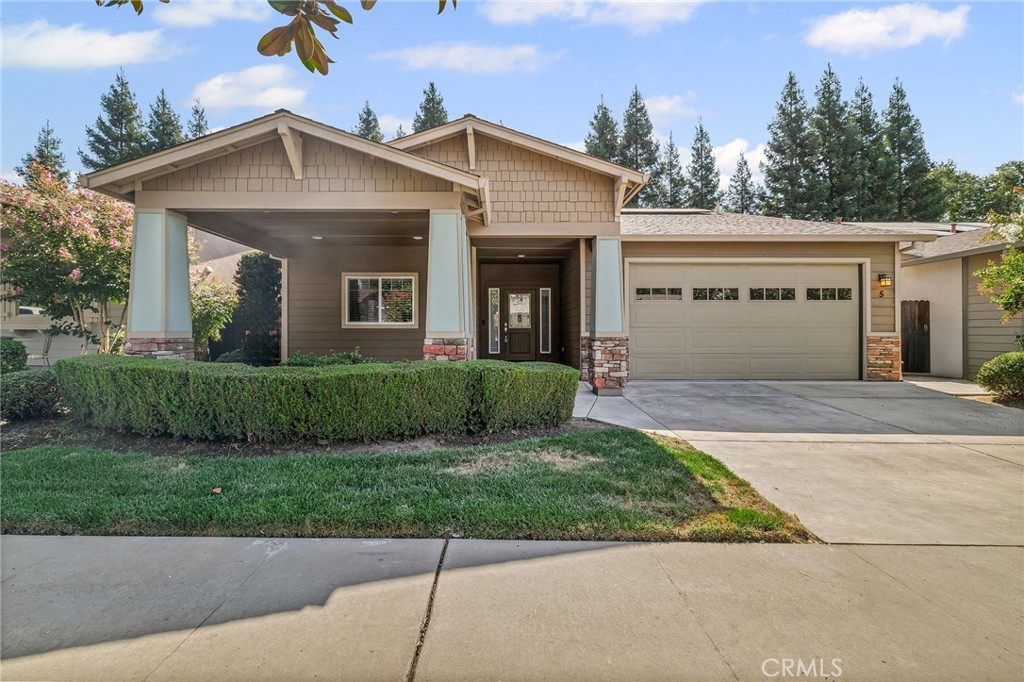 Welcome to 5 River Wood Loop, a rare opportunity to own a home in the charming and secluded River Glen neighborhood, where homes seldom come to market. This beautifully crafted single-story, Craftsman-style residence offers 3 bedrooms, 2 bathrooms, and over 1,932 sq. ft. of thoughtfully designed living space. Lovingly cared for by its original owner, this immaculate home is ready for its next chapter. The inviting front porch and manicured landscaping set the stage for what’s inside. Step through the formal entry and into the expansive living room, where engineered hardwood floors, a gas fireplace, and soaring ceilings create a spacious and welcoming place to gather with family and friends. The kitchen is a chef’s delight, featuring granite countertops, bar-top seating, tile floors, a pantry, a gas range, a built-in microwave above the stove, and a refrigerator. Its open layout flows seamlessly to the dining area, making it perfect for casual meals or hosting dinner parties. This home includes two generously sized guest bedrooms, both professionally designed by California Closets with custom built-ins, desks, and bookcases, ideal for home offices, guest rooms, or creative spaces. The hall bathroom is beautifully appointed with granite counters, tile floors, and plenty of storage. The primary suite is a true retreat, with tray ceilings, dual closets, and private access to the backyard. The ensuite bathroom features dual sinks, granite counters, a walk-in shower, soaking tub, and tile floors, creating a spa-like atmosphere to start and end your day. The backyard is low-maintenance and thoughtfully landscaped with mature trees, sprinklers, and a covered patio complete with a ceiling fan perfect for morning coffee, summer BBQs, or quiet evenings outdoors. Practical upgrades include a 6.210 kW OWNED SOLAR system installed by Solar Works in 2020, central HVAC with a newer motherboard, dual-pane windows, a spacious laundry room with utility sink and storage, and a finished garage with built-in storage and workbench. Located on the west end of Lindo Channel, you’re just a short stroll from the neighborhood community park, with easy access to bike paths, Oak Way Park, and Emma Wilson School. Plus, you’re only minutes from Downtown Chico and Chico State, offering the perfect blend of seclusion, convenience, and move-in-ready comfort. 5 River Wood Loop is more than a home; it’s a rare chance to put down roots in one of Chico’s most desirable neighborhoods.