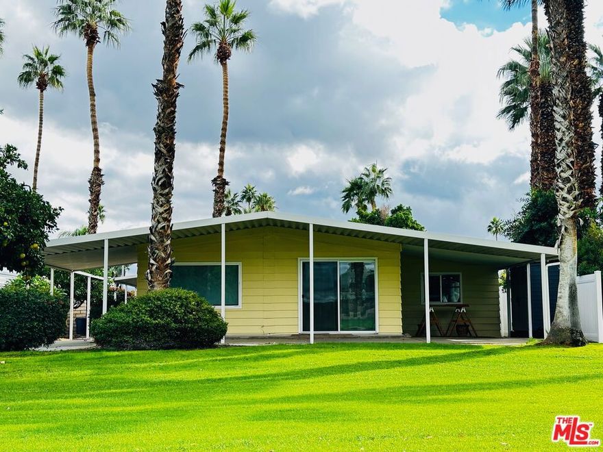 Welcome to 385 Avenida Andorra! Meticulously maintained and perfectly positioned, this golf course getaway enjoys picture-perfect mountain views all year long. Tastefully renovated throughout, with two bedrooms, two bathrooms (including a primary suite), a large living room, formal dining room w/ built-ins, great room with a wet bar, a renovated kitchen with stainless steel appliances and solid surface Corian countertops, updated baths, dedicated laundry room, contemporary laminate flooring throughout, dual pane windows and sliding glass doors, Bali window shades, central heat & air, workshop, large, wrap-around, covered lanai, attached carport, newer vinyl privacy fence, recent leveling and stabilization... the list goes on and on! Conveniently located within the community, with easy access to the park's satellite pool and fitness room, as well as the back gate (off Da Vall Drive). Date Palm Country Club is a 55+ community. The monthly lot rent includes park amenities (golf is additional). This one is priced to move quickly.  Schedule your tour today!