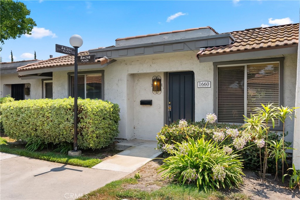 Welcome to 1660 W Recreo Plaza—a charming single level two-bedroom, two-bathroom home offering comfort, functionality, and convenience in the heart of Anaheim. With a thoughtfully designed living space and direct 2-car garage access, this home is a wonderful opportunity for those looking to simplify and enjoy low-maintenance living. As you step inside, the kitchen and dining area greet you creating a welcoming space for meals and gatherings. The kitchen features a breakfast bar that flows easily into the spacious living room, making it simple to stay connected with guests or loved ones while you cook. A large sliding glass door brings in natural light and opens to a private back patio—perfect for relaxing or entertaining outdoors. A stylish pergola offers shade while still allowing soft daylight to filter into the living space. The primary suite offers a peaceful retreat with on suite bathroom, a practical walk-in closet, and private access to the back patio—ideal for enjoying quiet mornings or evening breezes. The second bedroom is equally inviting, offering flexibility for kids, guests, or an office to fit your work-from-home needs. A full hallway bath is conveniently located next to the second bedroom. Whether you're a first-time buyer, downsizing, or seeking an investment opportunity, this home checks all the right boxes with its thoughtful layout, functional updates, and prime Anaheim location.