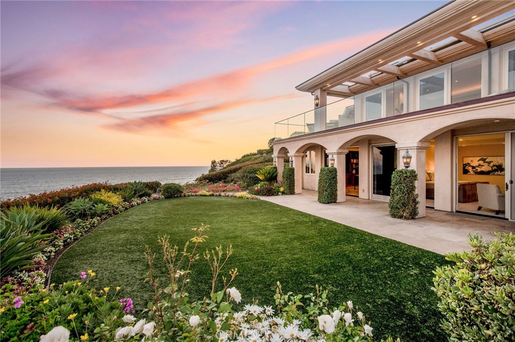 This stunning oceanfront home is angled on an elevated promontory capturing miles of uninterrupted coastline and cerulean blue ocean as far as the eye can see. Built in 2003, the spacious 10,900 square foot contemporary home unfolds with an impressive entry, wide gallery halls, volume ceilings, floor-to-ceiling glass, wonderful natural light and warm ocean breezes. The breathtaking ocean views extend past broad limestone terraces while a secluded central courtyard is perfect for entertaining with outdoor fireplace, cook center, and spa. Five en suite bedrooms include well-designed guest quarters, a chef-grade kitchen with Butler’s pantry and caterer’s entry, dramatic living room with wrap-around views, two elevators, wine cellar, and oversized motor court leading to three car garage. Monarch Bay is a guard-gated community, tennis, private Beach Club on the sand, and rests in close proximity to Monarch Links Golf, Monarch Bay Resort, Ritz Carlton and Montage Resorts. Considered the premier oceanfront location in Monarch Bay, this fine residence offers unmatched space, design and coastal views above the crashing surf.