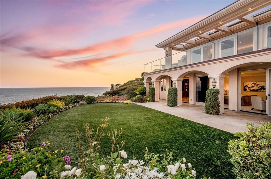 This stunning oceanfront home is angled on an elevated promontory capturing miles of uninterrupted coastline and cerulean blue ocean as far as the eye can see.  Built in 2003, the spacious 10,900 square foot contemporary home unfolds with an impressive entry, wide gallery halls, volume ceilings, floor-to-ceiling glass, wonderful natural light and warm ocean breezes.  The breathtaking ocean views extend past broad limestone terraces while a secluded central courtyard is perfect for entertaining with outdoor fireplace, cook center, and spa.  Five en suite bedrooms include well-designed guest quarters, a chef-grade kitchen with Butler’s pantry and caterer’s entry, dramatic living room with wrap-around views, two elevators, wine cellar, and oversized motor court leading to three car garage.  Monarch Bay is a guard-gated community, tennis, private Beach Club on the sand, and rests in close proximity to Monarch Links Golf, Monarch Bay Resort, Ritz Carlton and Montage Resorts.  Considered the premier oceanfront location in Monarch Bay, this fine residence offers unmatched space, design and coastal views above the crashing surf.
