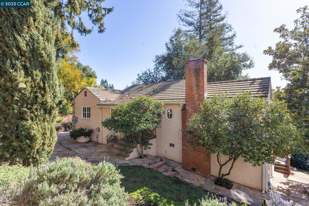 OH Saturday and Sunday, 1 to 4 PM - $350,000 price reduction from original $1,795,000 listing price! Nestled in Orinda’s Country Club neighborhood on a peaceful .3-ac lot, this enchanting 4BR/3.5BA home is a vibrant sanctuary for a family to thrive. Enjoy 2400+ sf of flexible indoor space—the central home, an ADU, and a modular office within magical gardens. The Central Home features HW floors and Euro double pane doors/windows, flooding the main floor with natural light. The master bedroom boasts ample closet space and ensuite bath with two add bedrooms, another full bath, and cozy family room downstairs. Prepare meals in the chef's kitchen, gather in the sunny dining room, or dine al fresco on the spacious wraparound deck. And unwind in the living room or on the connected patio with views of the SW Oakland Hills. An ADU with a balcony provides flexible space—a guest suite for family/friends, a bedroom/playroom for kids, a home office, or rental unit. And a modular office with electricity offers a dedicated workspace for parents just steps from the main house. Relax amongst exotic gardens with palm trees and redwoods, flagstone pathways that lead to tranquil seating areas, and a lawn for play structures or vegetable beds.